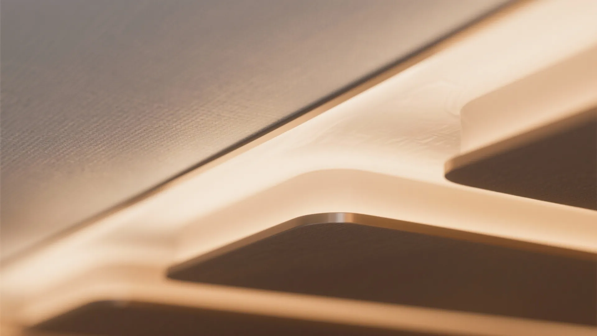 Close up view of warm hidden light fixture glowing along a modern white wall panel edge