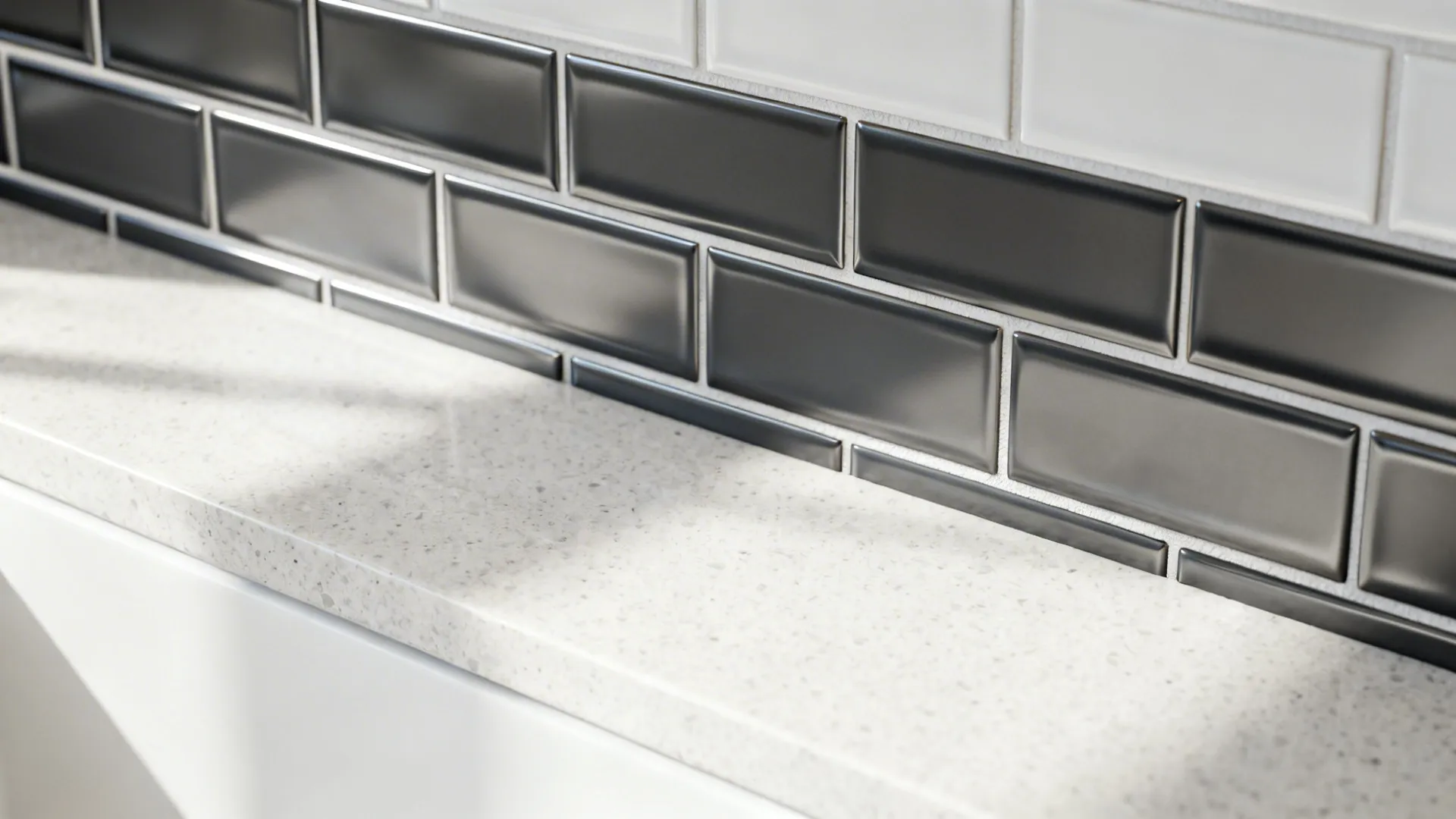 Macro detail of charcoal stripe tiles above a quartz counter with precise grout and satin finish.