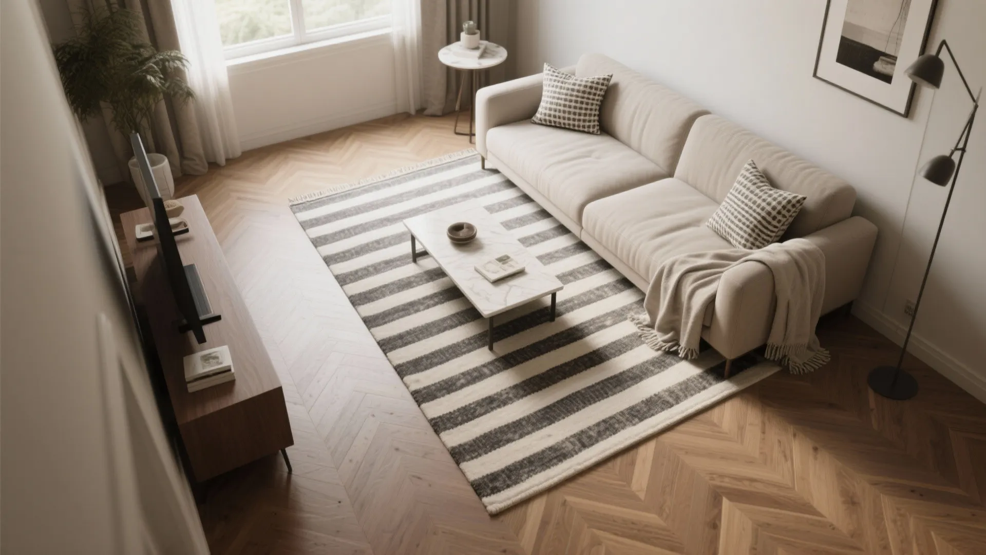 Top-down layout with a subtle striped rug oriented lengthwise and a quiet border aligned to the coffee table.