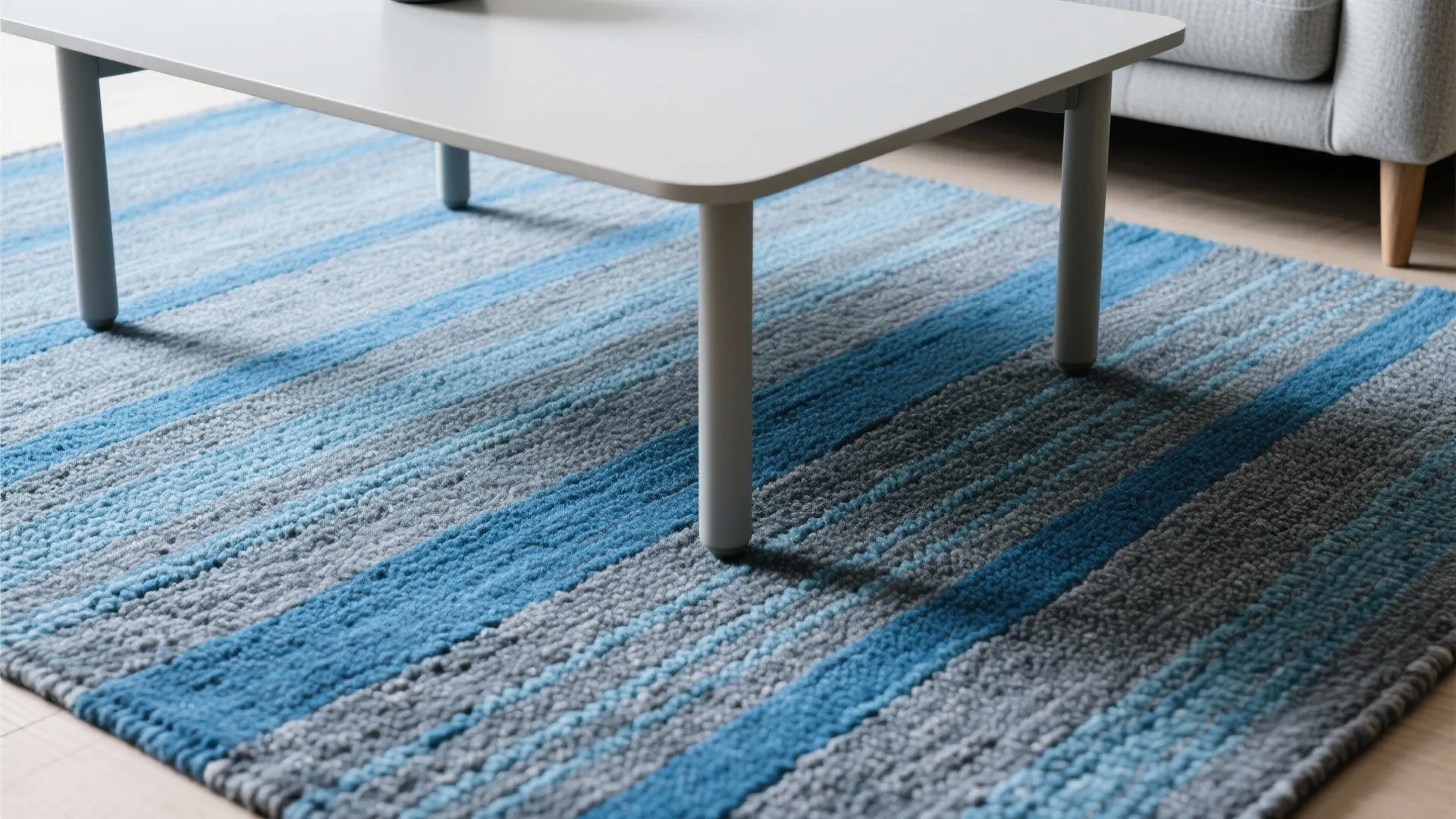 Blue and grey striped wool rug under a coffee table