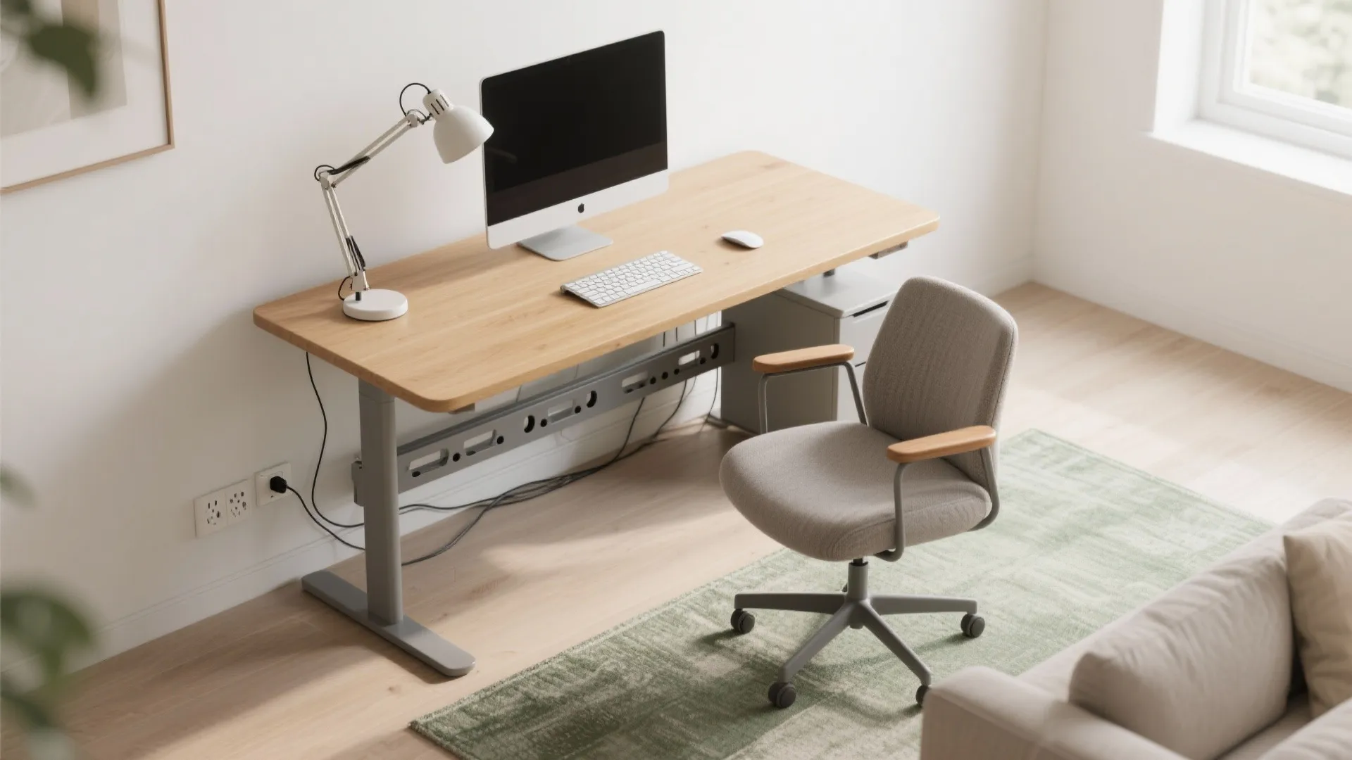 Top view of a modern home office with wooden desk computer grey chair and rug