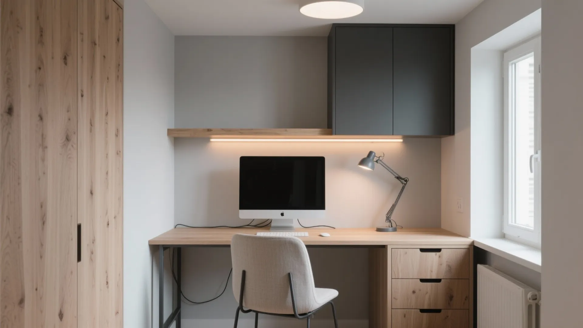 Modern home office with wooden desk computer grey chair black cabinet and bright window light