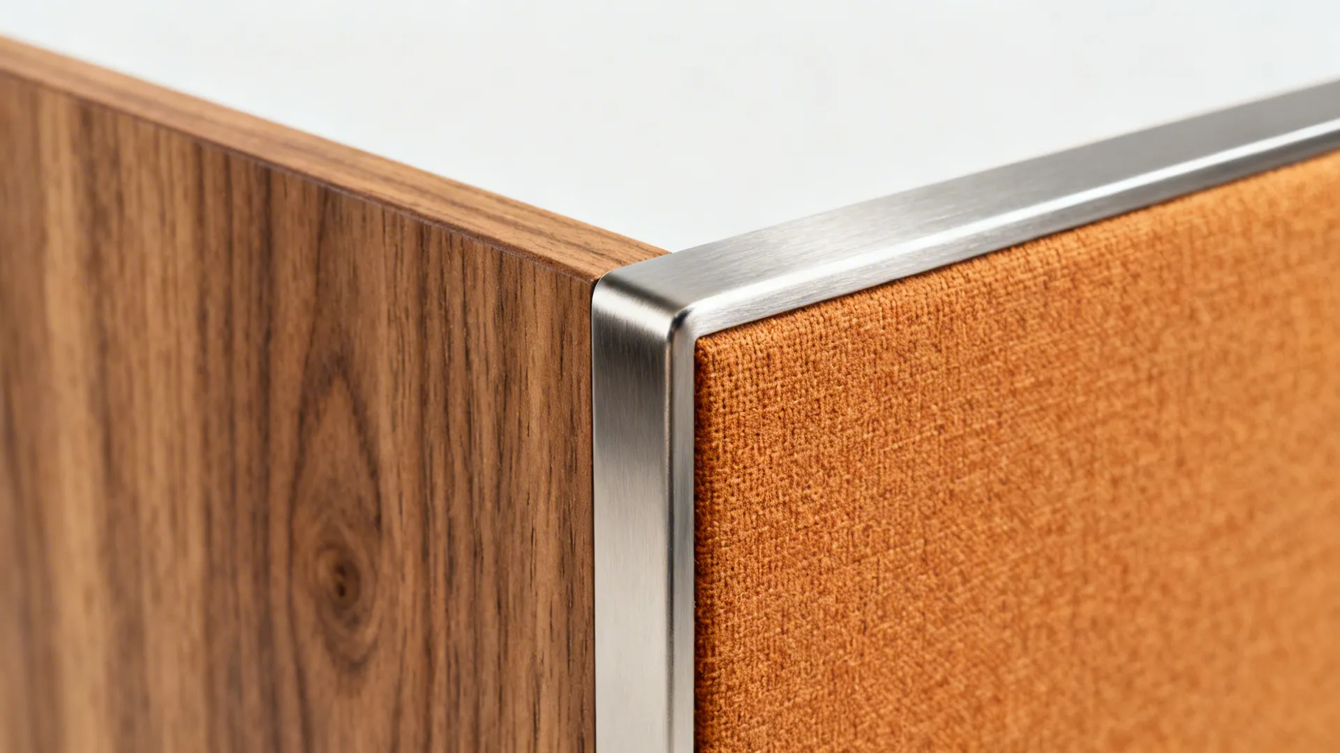 Macro of oak grain, brushed nickel, and warm fabric swatch under soft daylight.