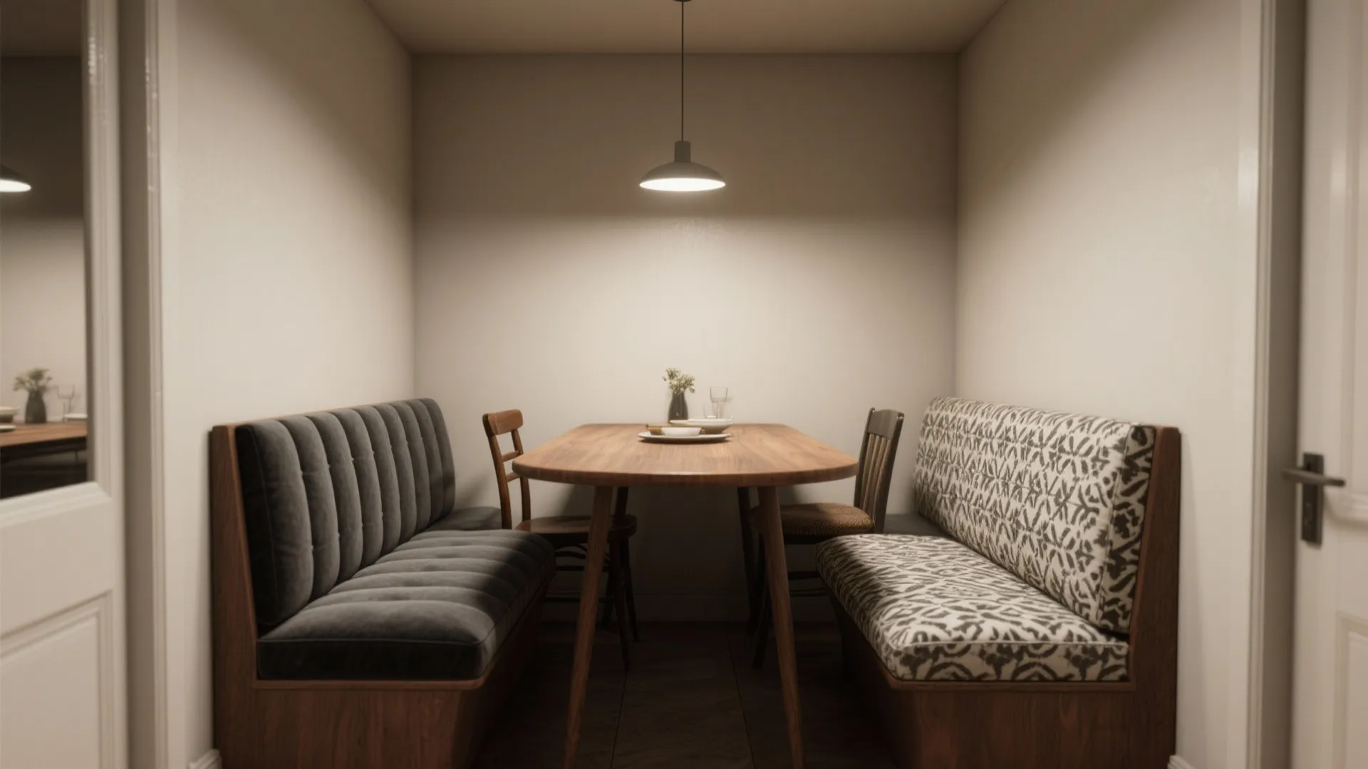 Small dining area with wooden table plus grey and patterned sofa benches under ceiling light