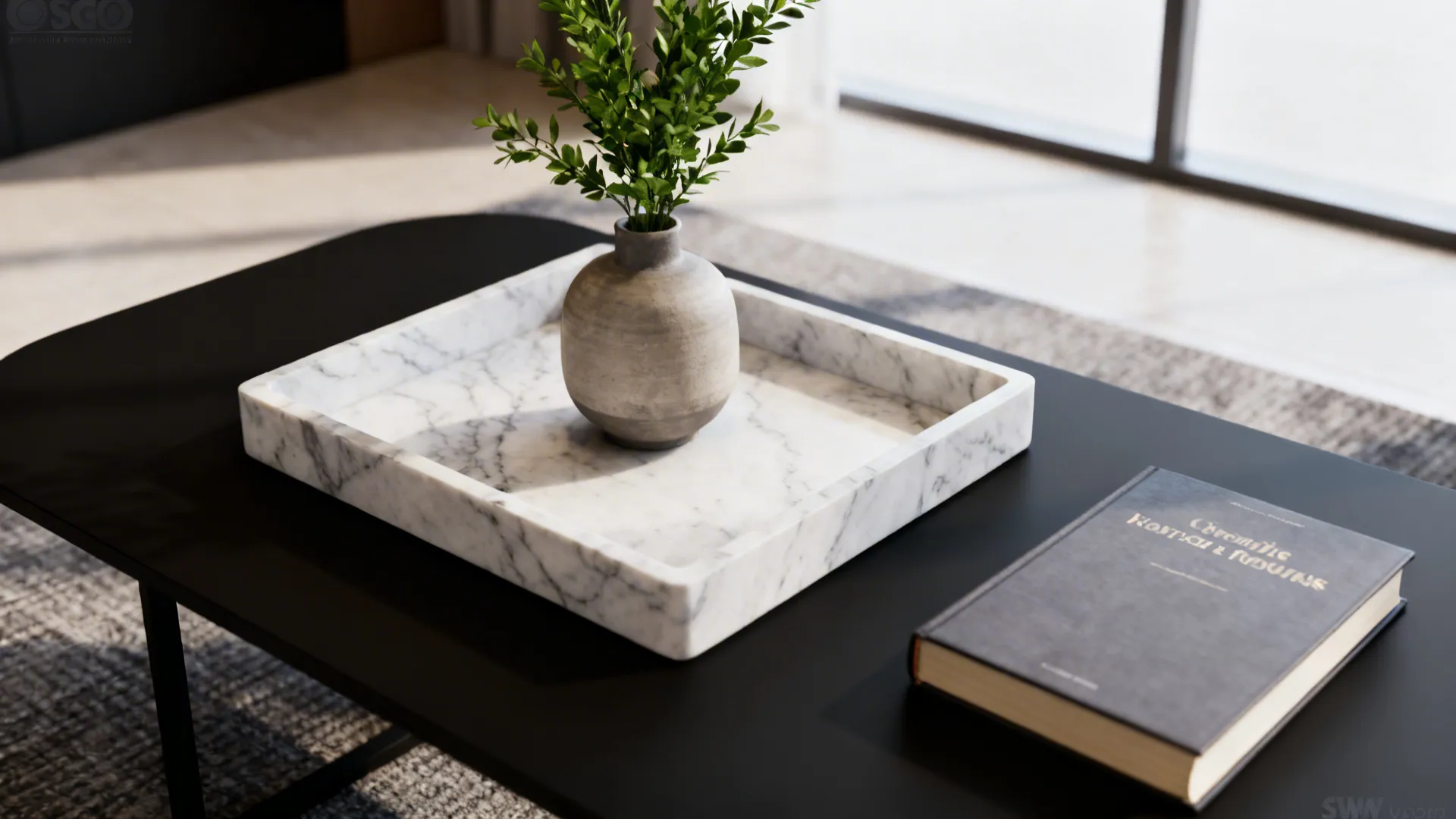 Minimal trio styling on a black coffee table: tray, vase, and book