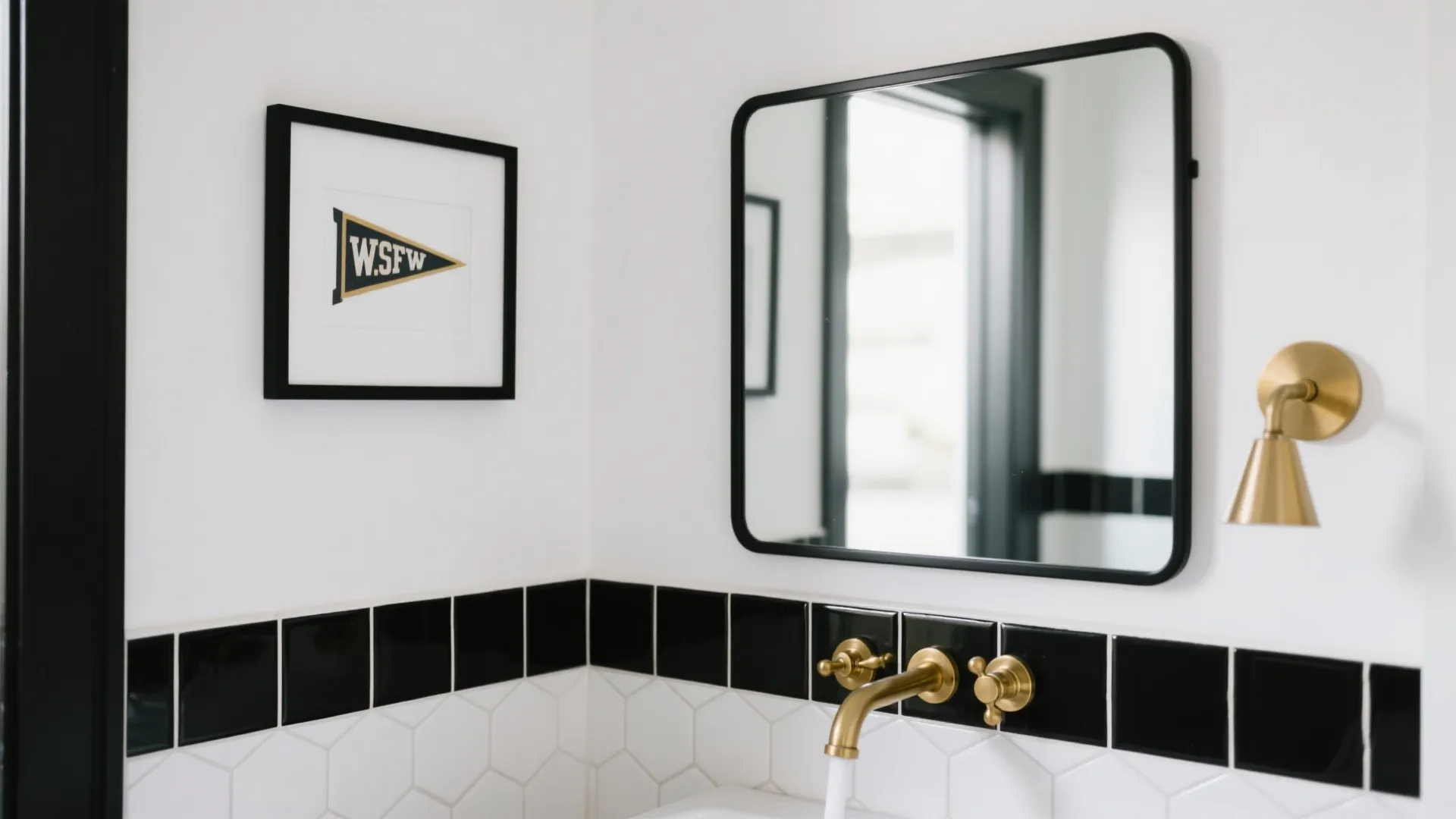 Vanity wall with white hex tile, charcoal grout, and a small framed pennant without logos above the sink.
