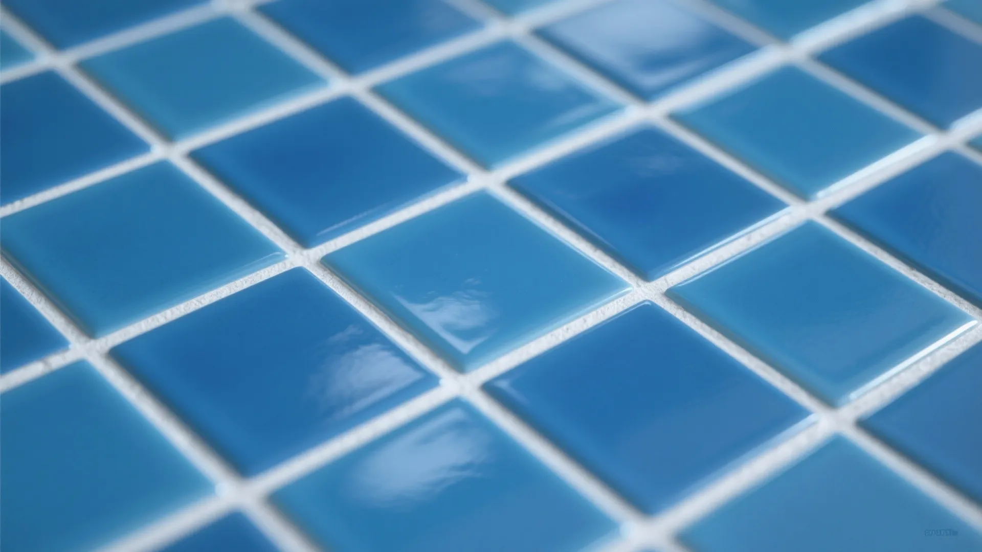 Close up view of glossy blue square wall tiles with white grout in a bright kitchen