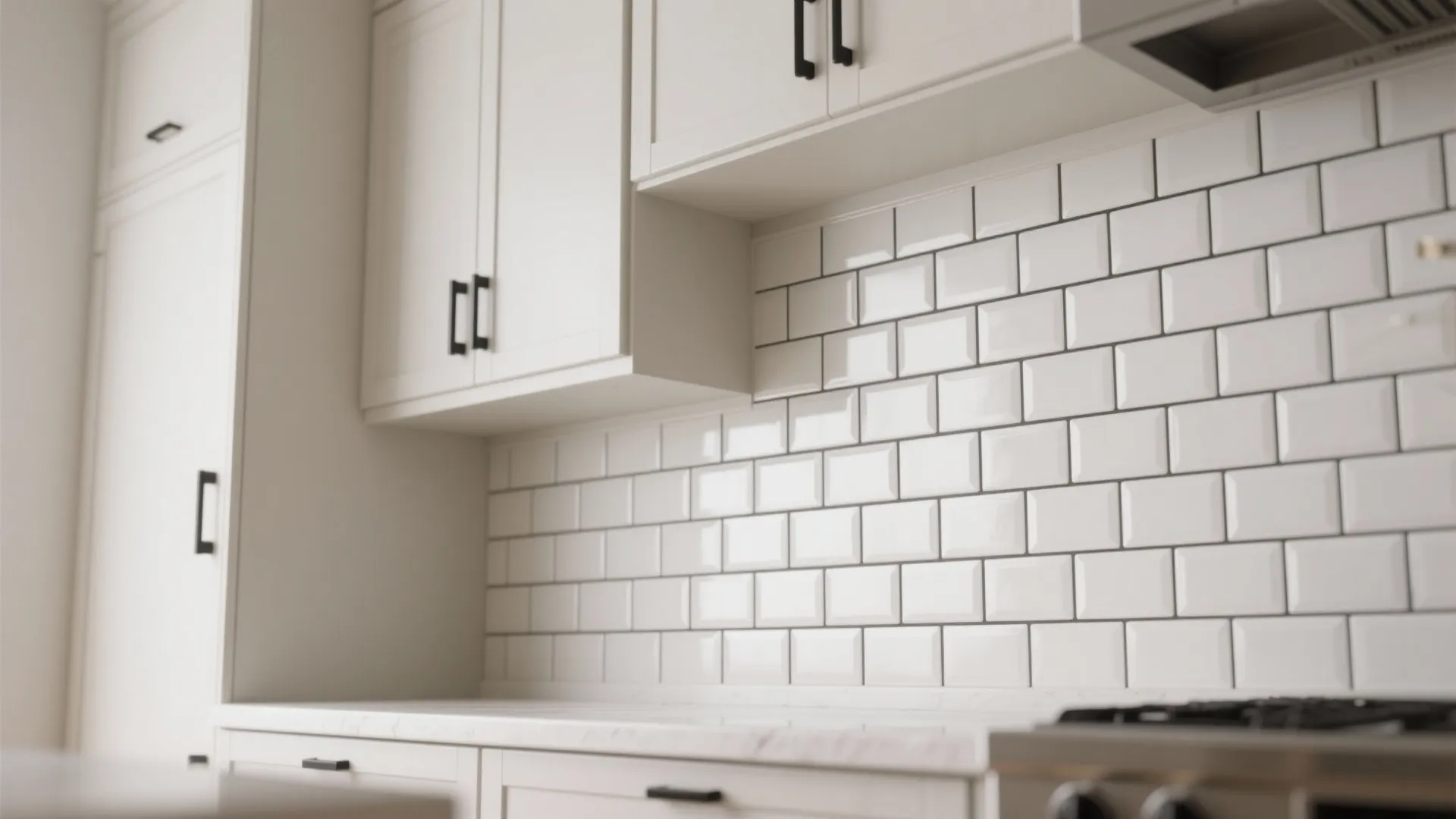 Glossy off-white subway tile backsplash with charcoal grout and vertical stack inset in a modern white kitchen.