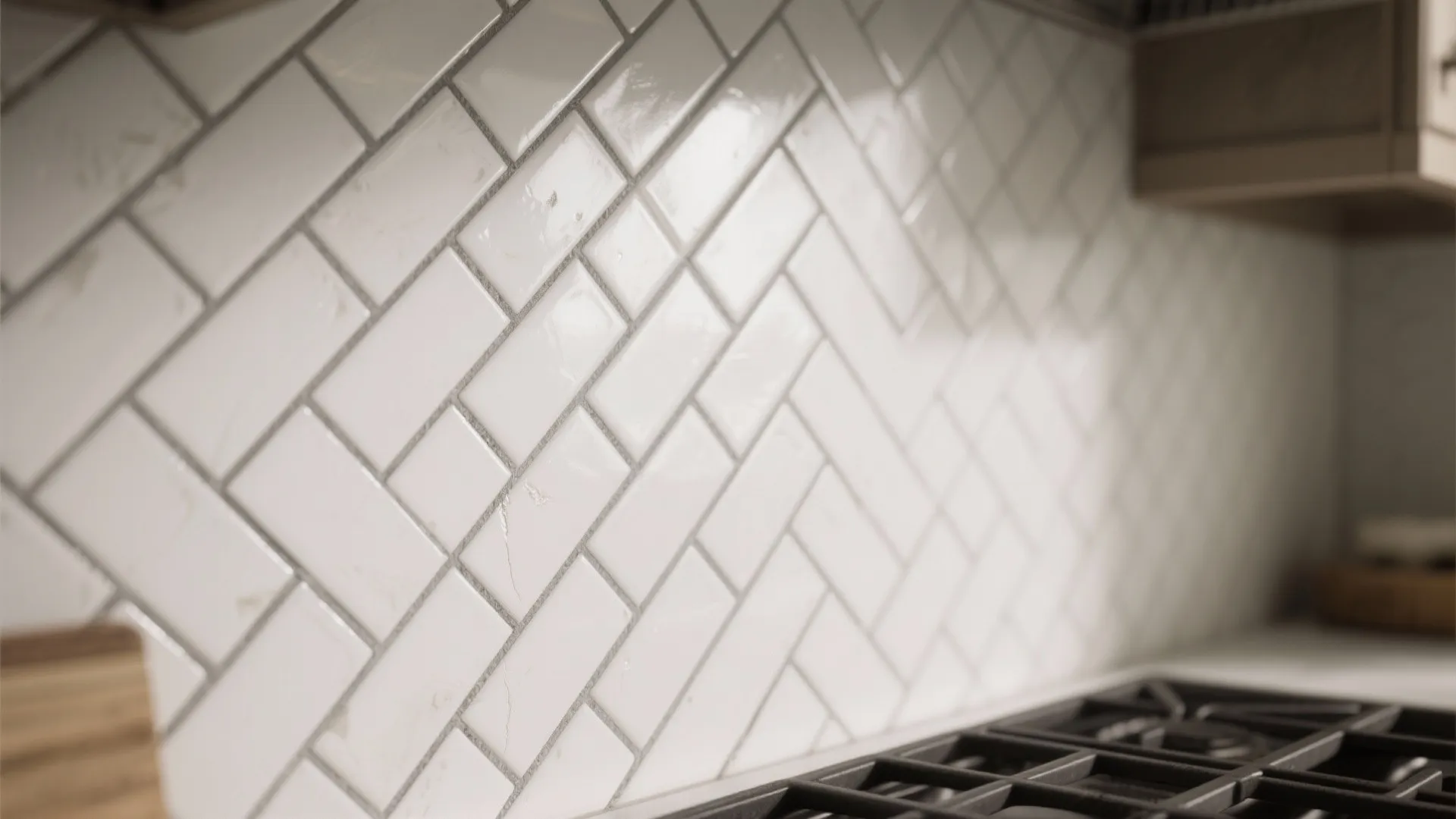 Close up of white wall tiles in a diagonal pattern with grey grout behind kitchen stove
