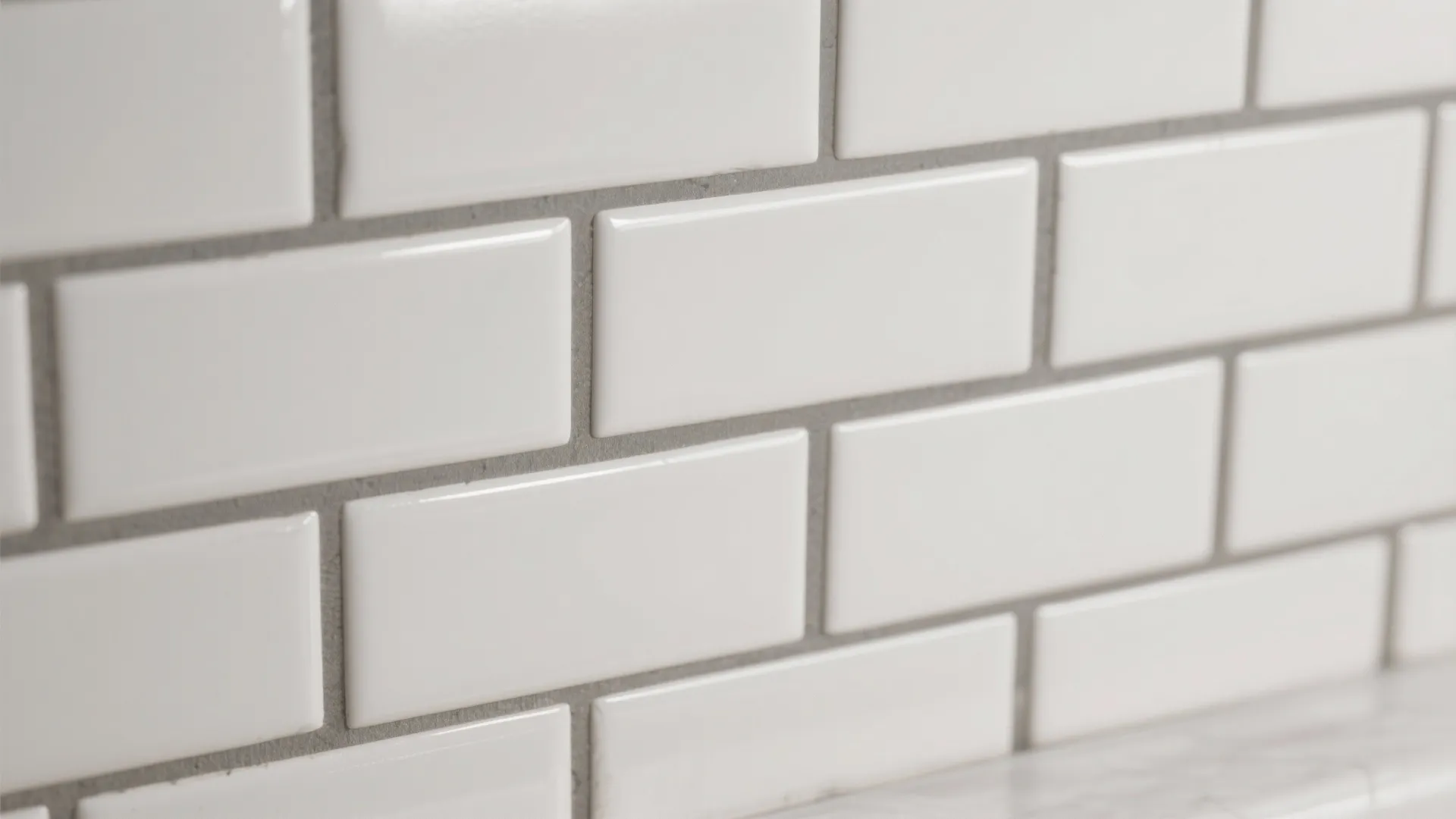 Close up of white rectangular wall tiles with grey grout for a kitchen or bathroom