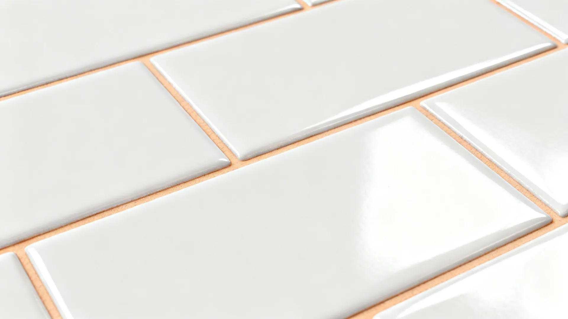 Macro view of glossy subway tiles with ultra-thin warm white grout lines and clean edges.