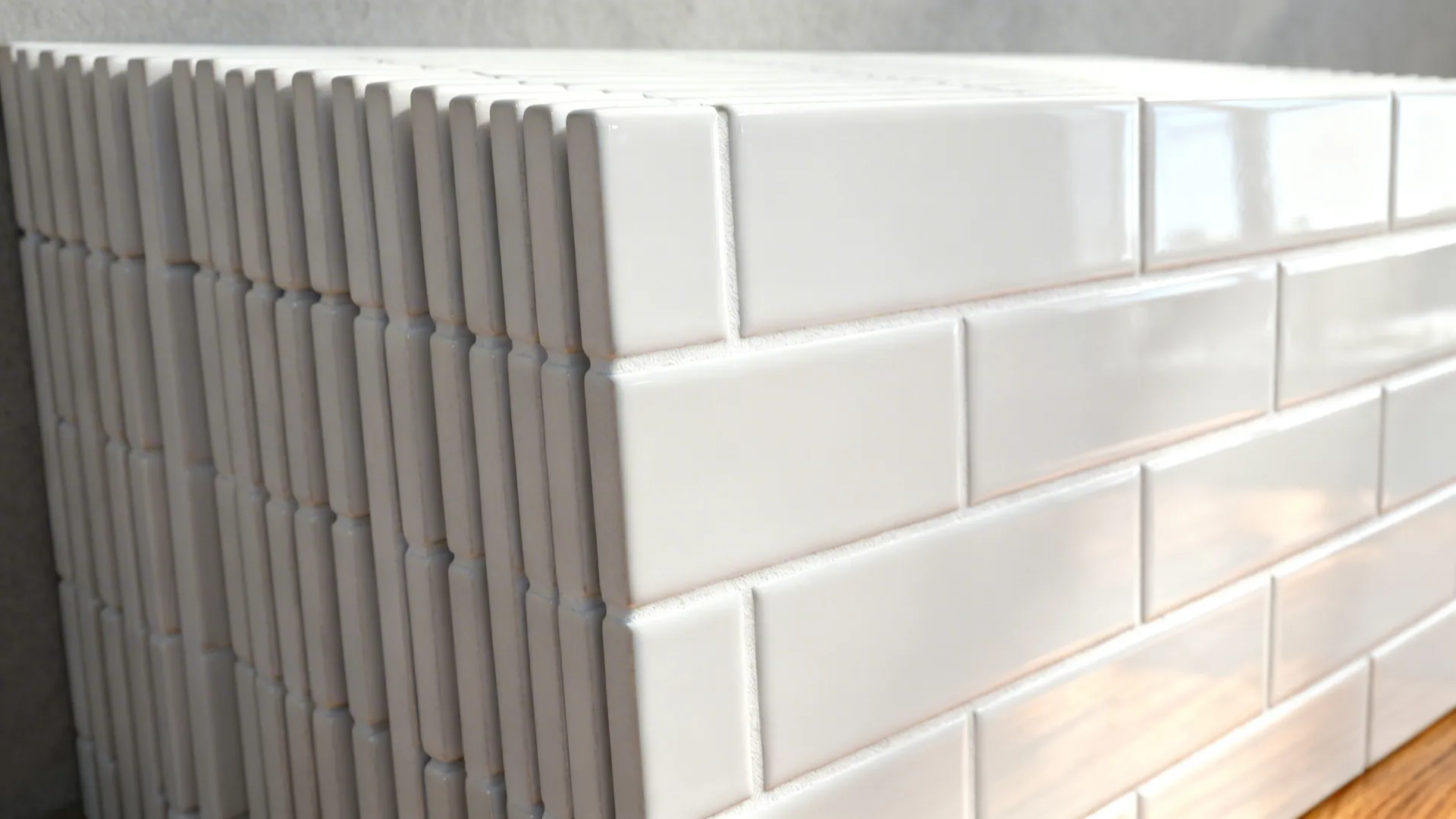 Macro of vertical stacked matte subway tiles with tight white grout lines.