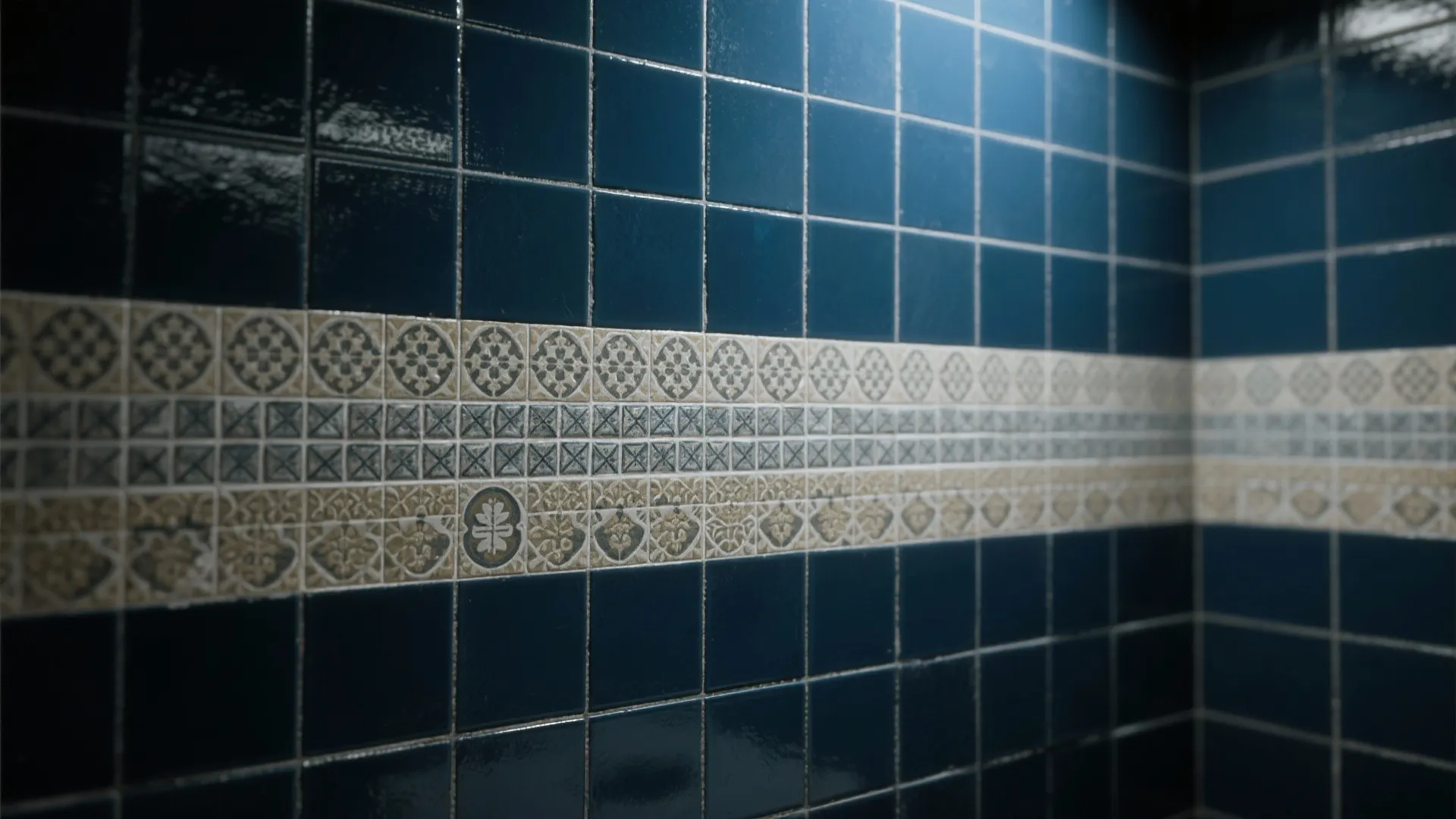 Dark blue wall tiles featuring a decorative middle row with white and grey pattern designs
