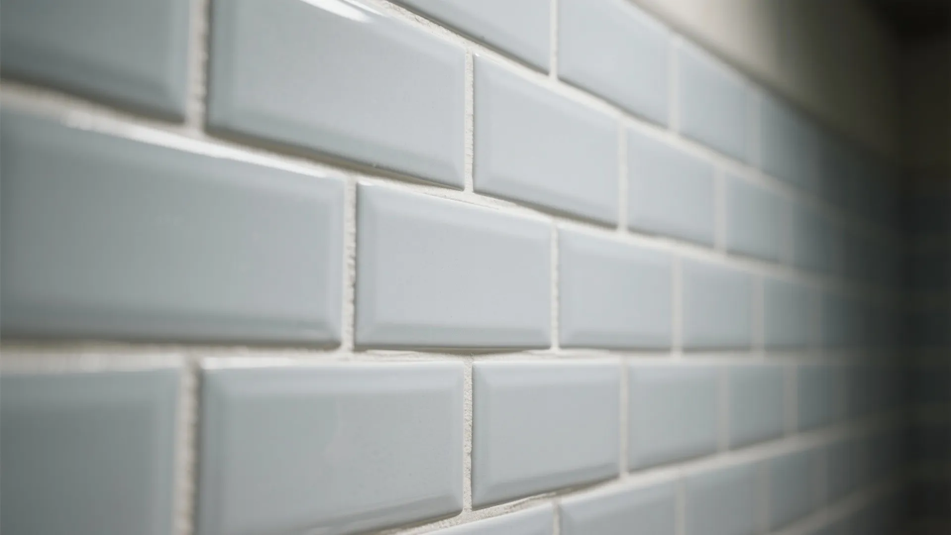 Soft grey subway tiles with matching off-white grout creating a seamless serene wall