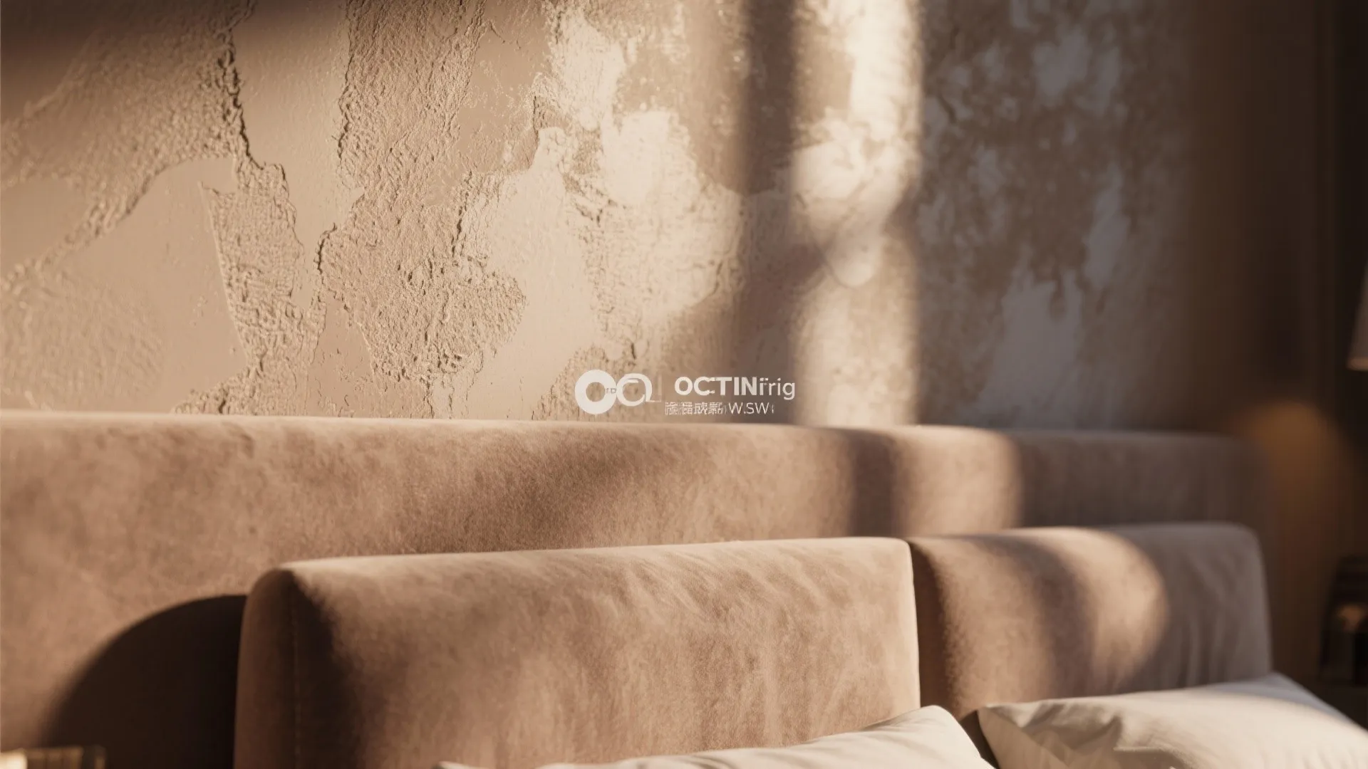 Close up of a soft brown bed headboard against a textured light brown painted wall