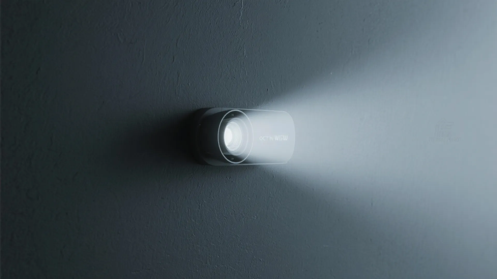 Close up view of a small white wall light emitting a bright beam of light