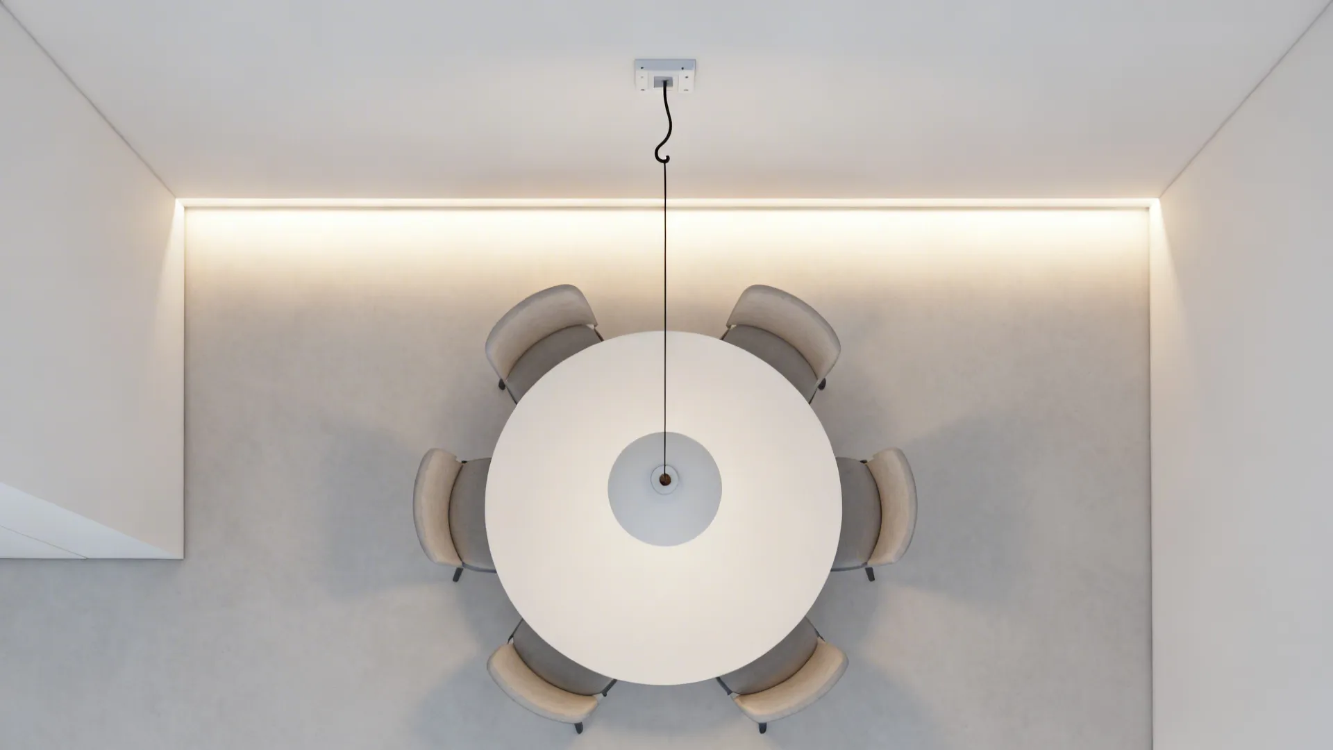 Top view of white round dining table with six grey chairs and a hanging ceiling light