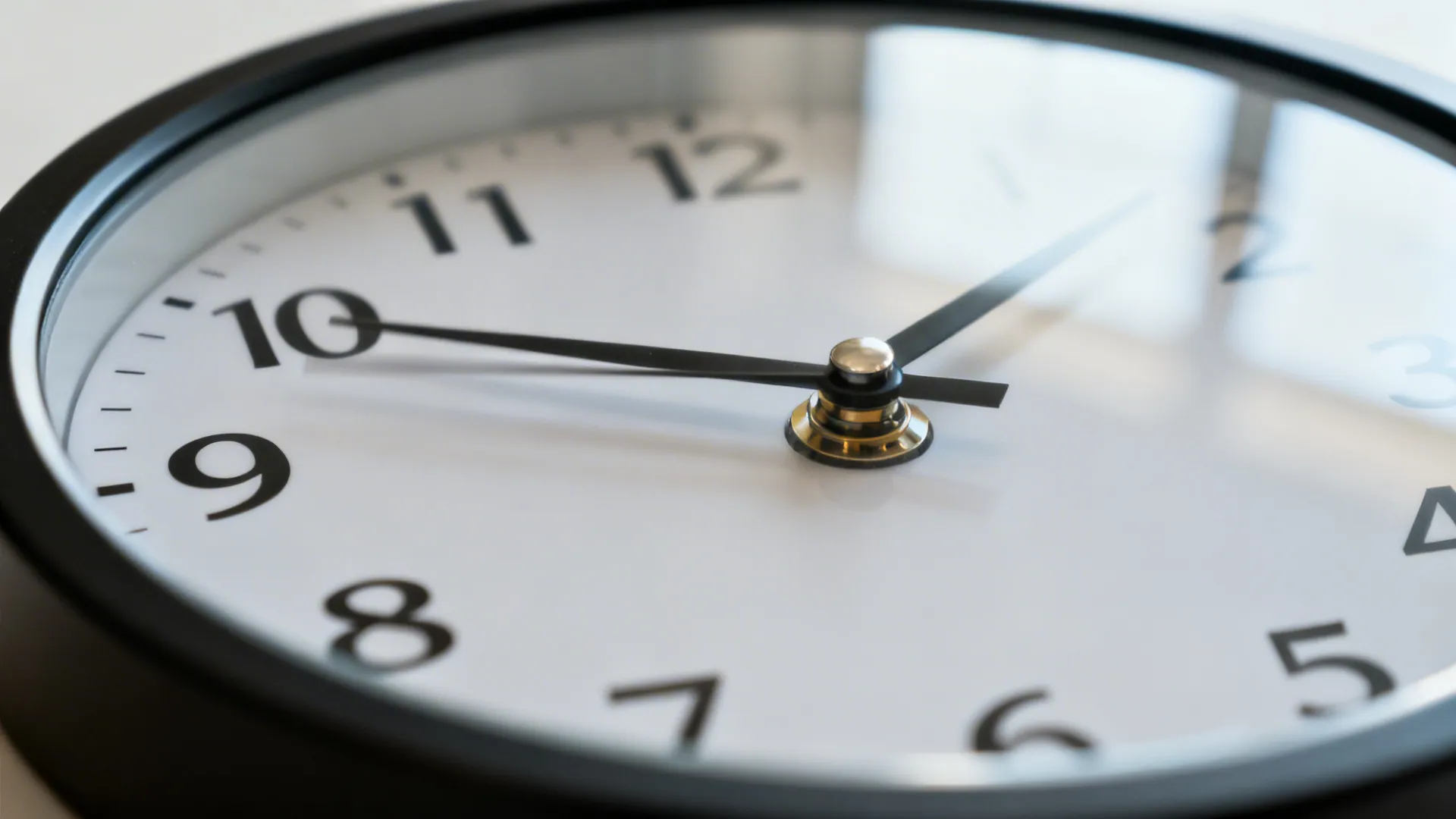 Macro of a silent sweep clock with a smoothly moving second hand and matte bezel.