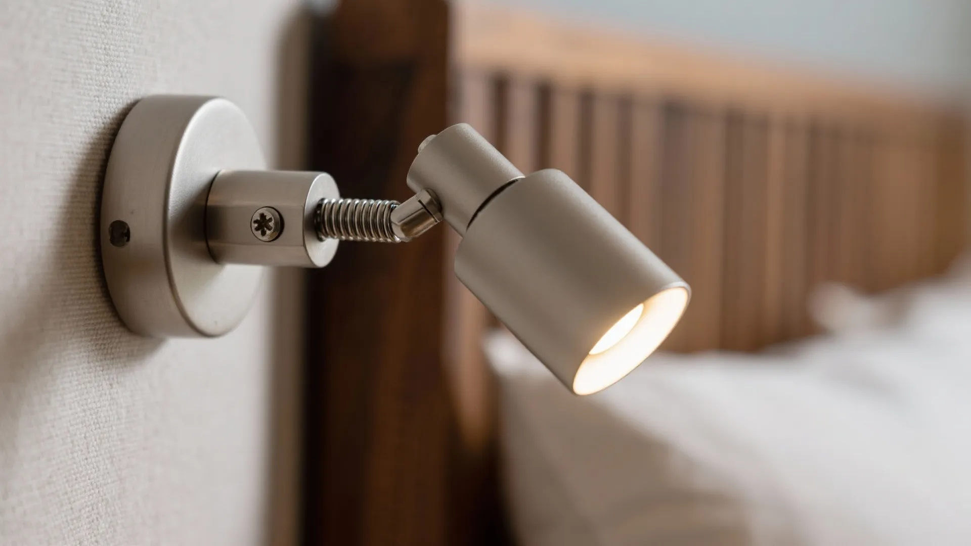 Articulated Swing-Arm Sconces Above the Headboard