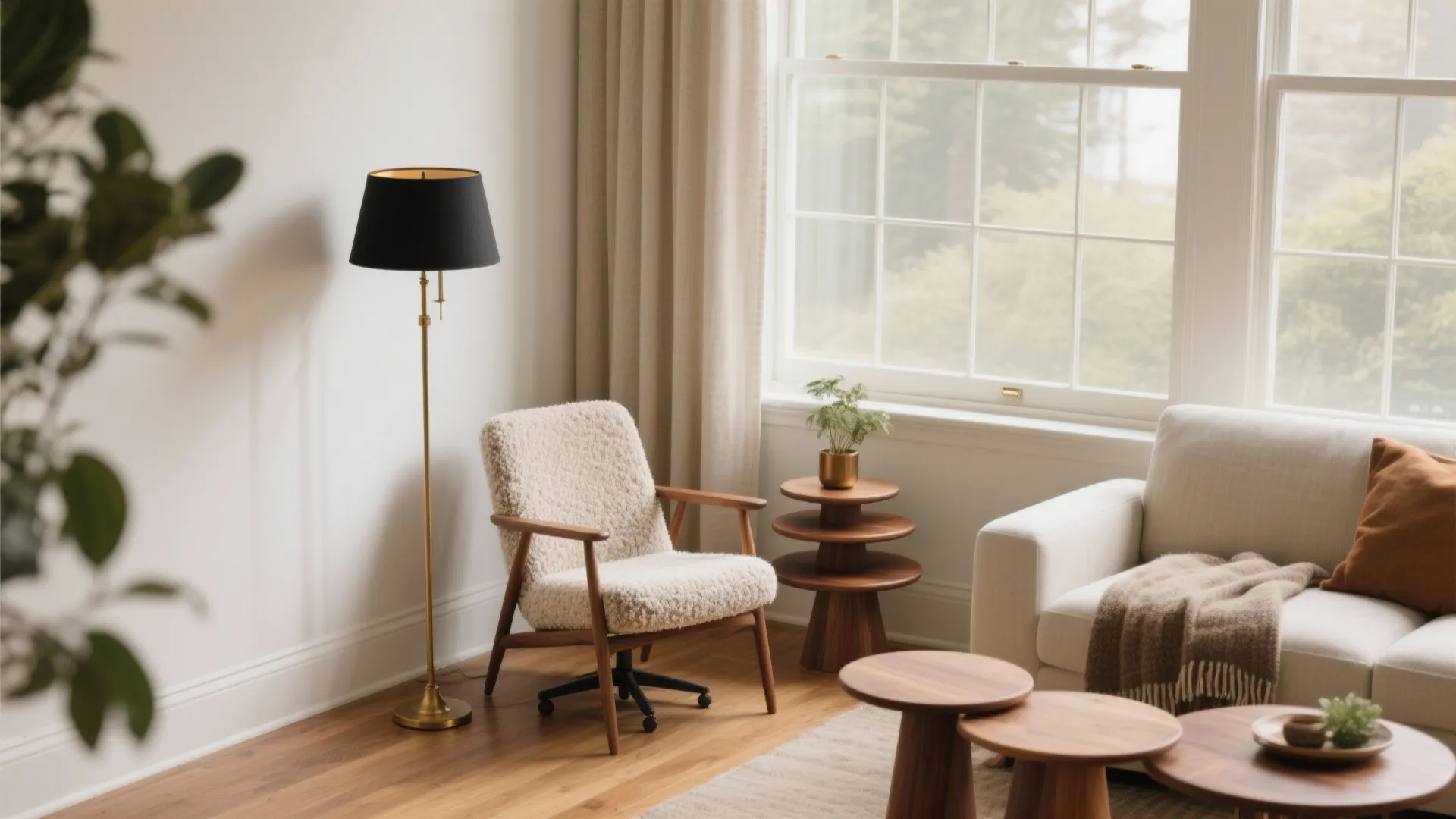 Cozy living room corner with cream swivel chair gold floor lamp wooden tables and large window