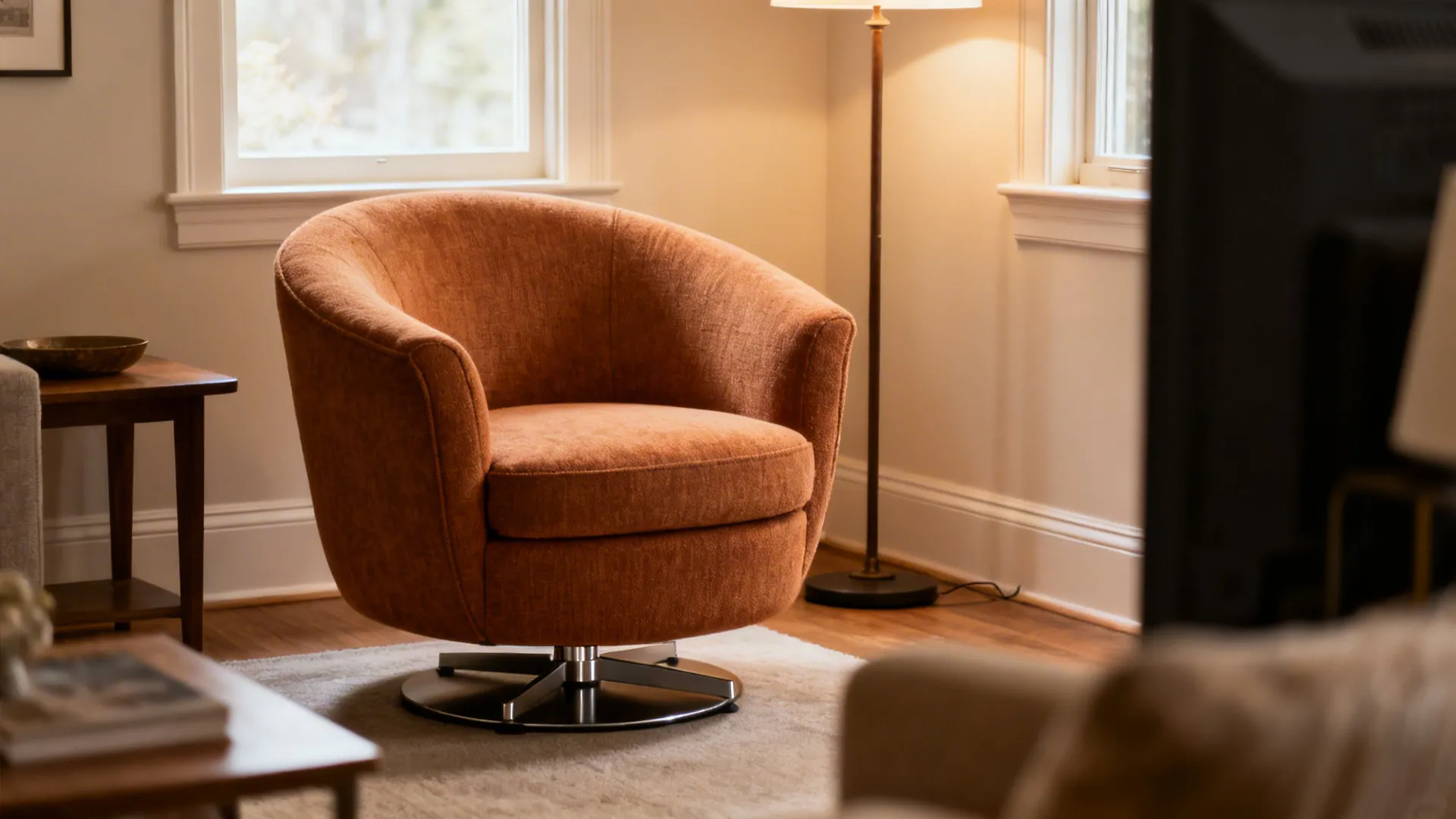 Cozy swivel tub chair with rounded silhouette and visible swivel base in a small living room corner.