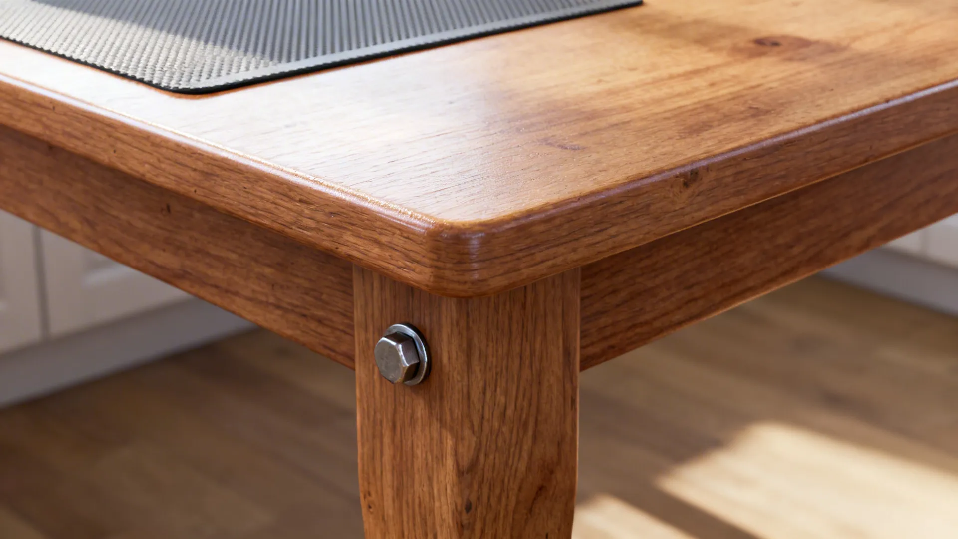 Macro detail of sealed wood table with silicone mat and tightened hardware for long-term durability.