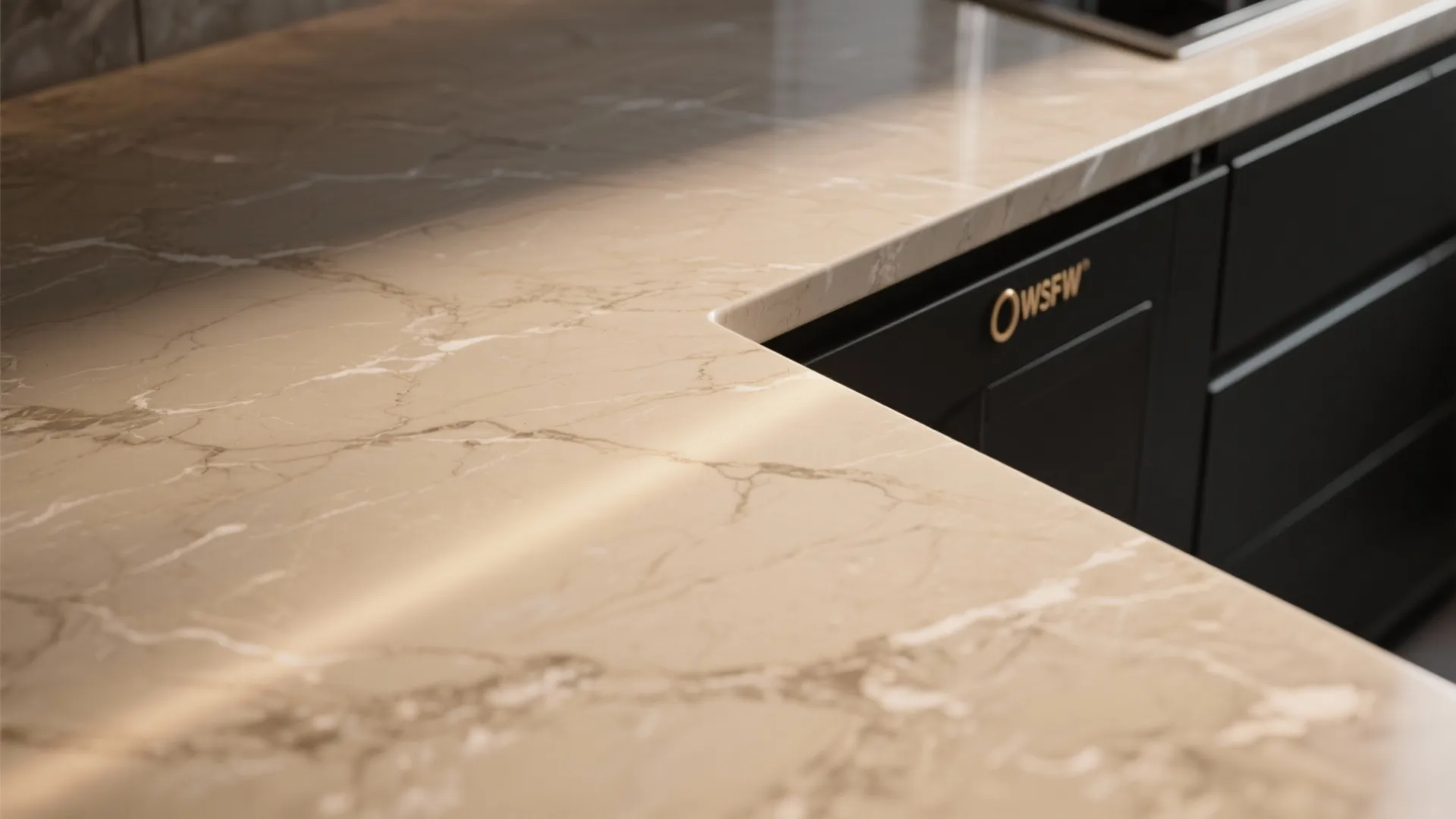 Close-up view of a tan marble kitchen countertop texture next to dark black wooden cabinets