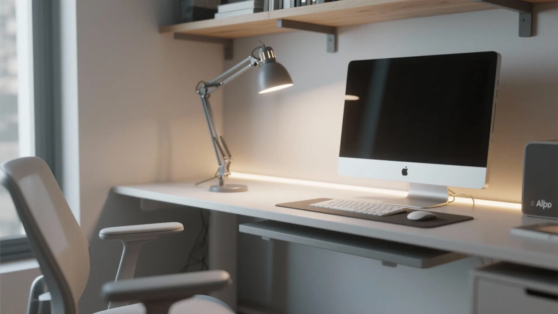 White office desk with computer and desk light plus grey chair in bright natural light