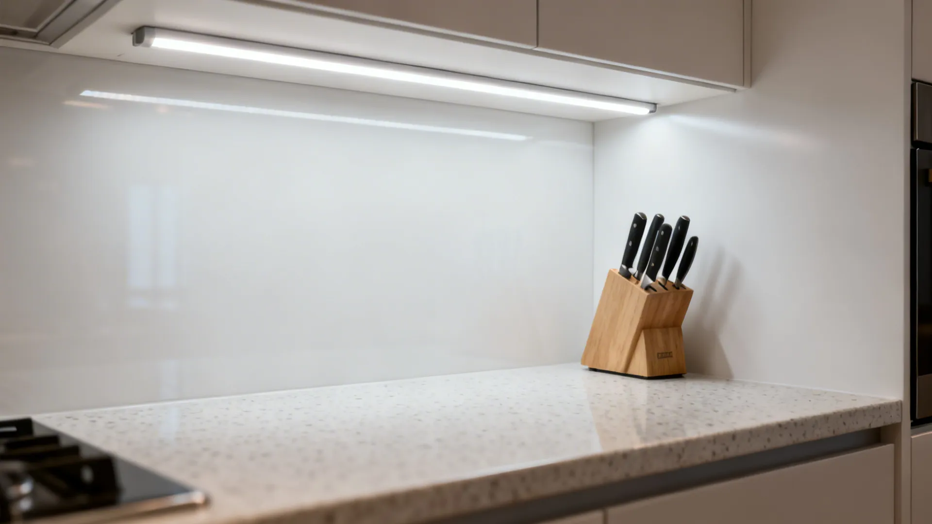 Macro of under-cabinet 3000K LED task lighting on a compact prep zone.