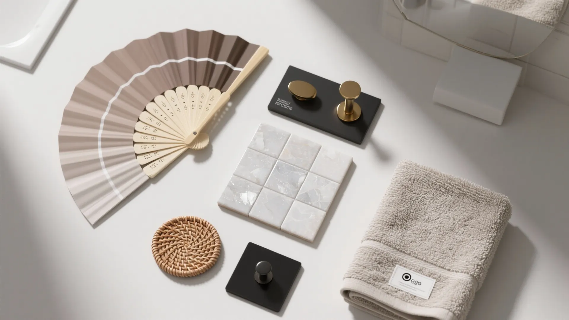 Flatlay of taupe paint swatches, tile sample, quartz chip, and hardware samples for budget upgrades