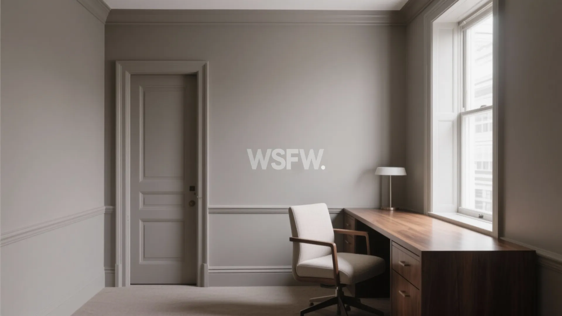 Minimalist home office with taupe wall panel wooden desk white chair and window with light