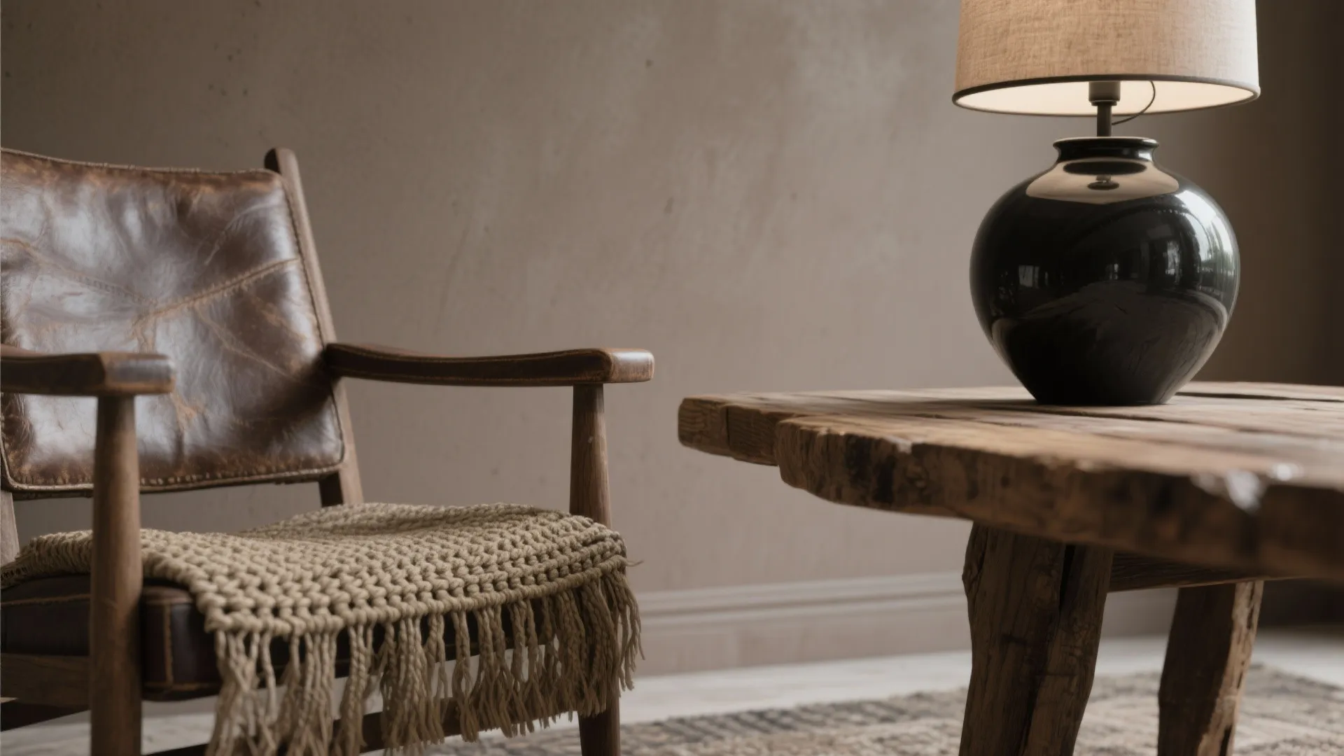 Vintage leather chair with woven cushion next to a rustic wood table and black lamp