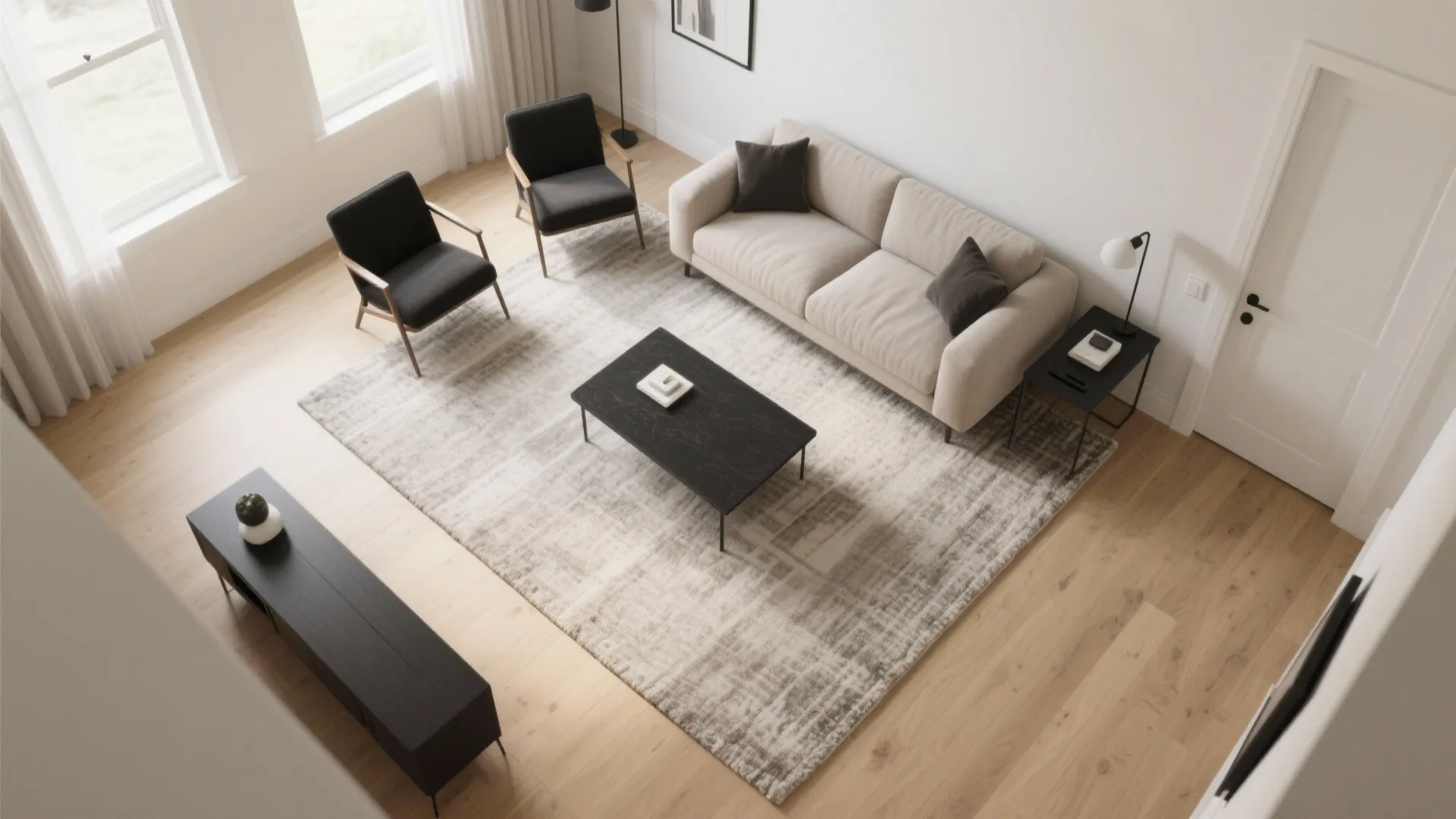 Modern living room from above with beige sofa black coffee table rug and two dark chairs