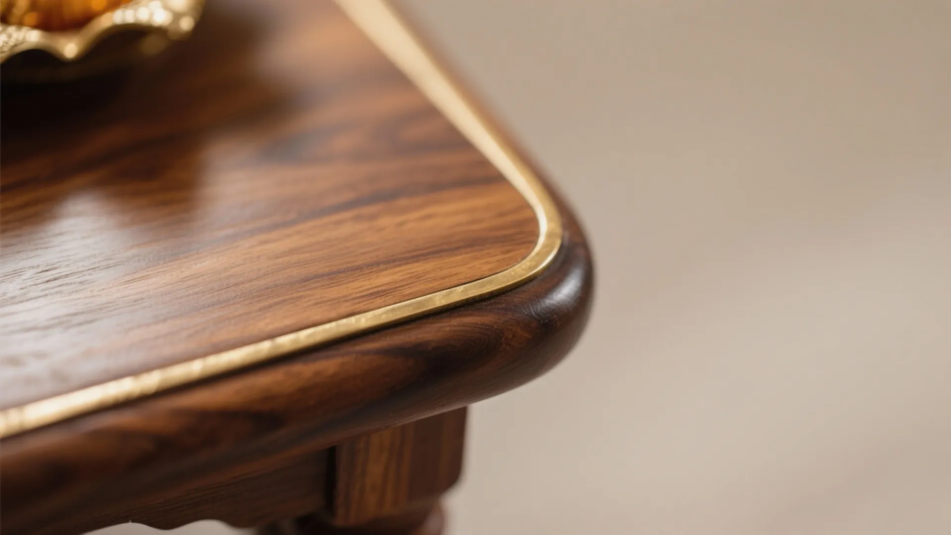 Close-up of rounded teak edge with slim brass inlay under soft daylight.