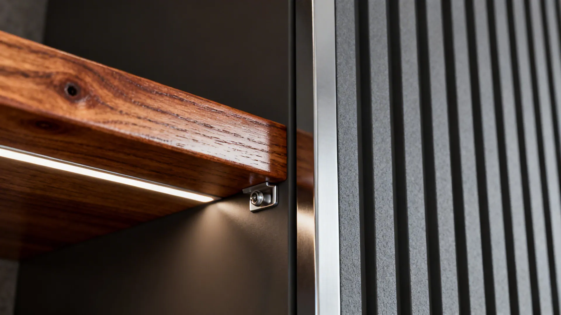 Macro of oiled teak shelf next to composite slat cabinet with stainless fastener detail.