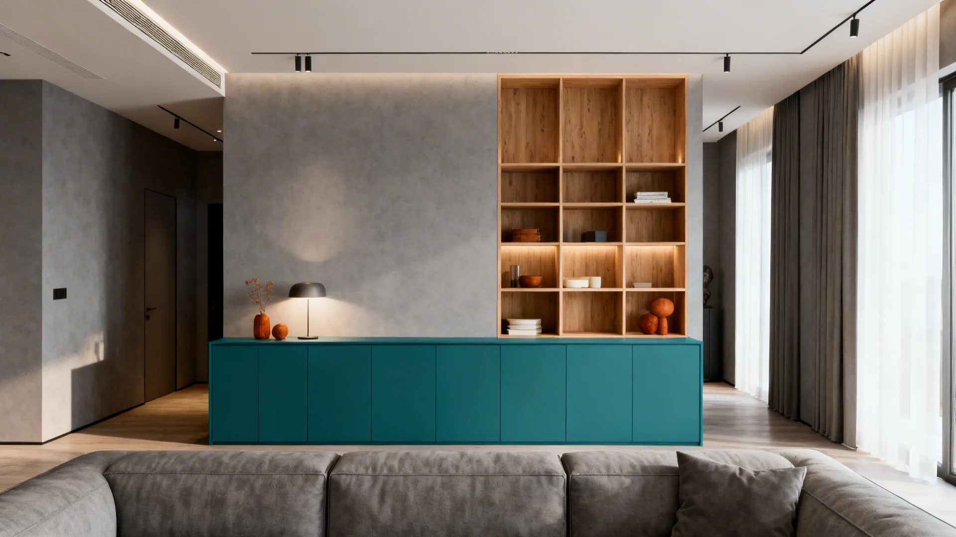 Open-plan living area with teal lower cabinets, gray walls and natural wood accents