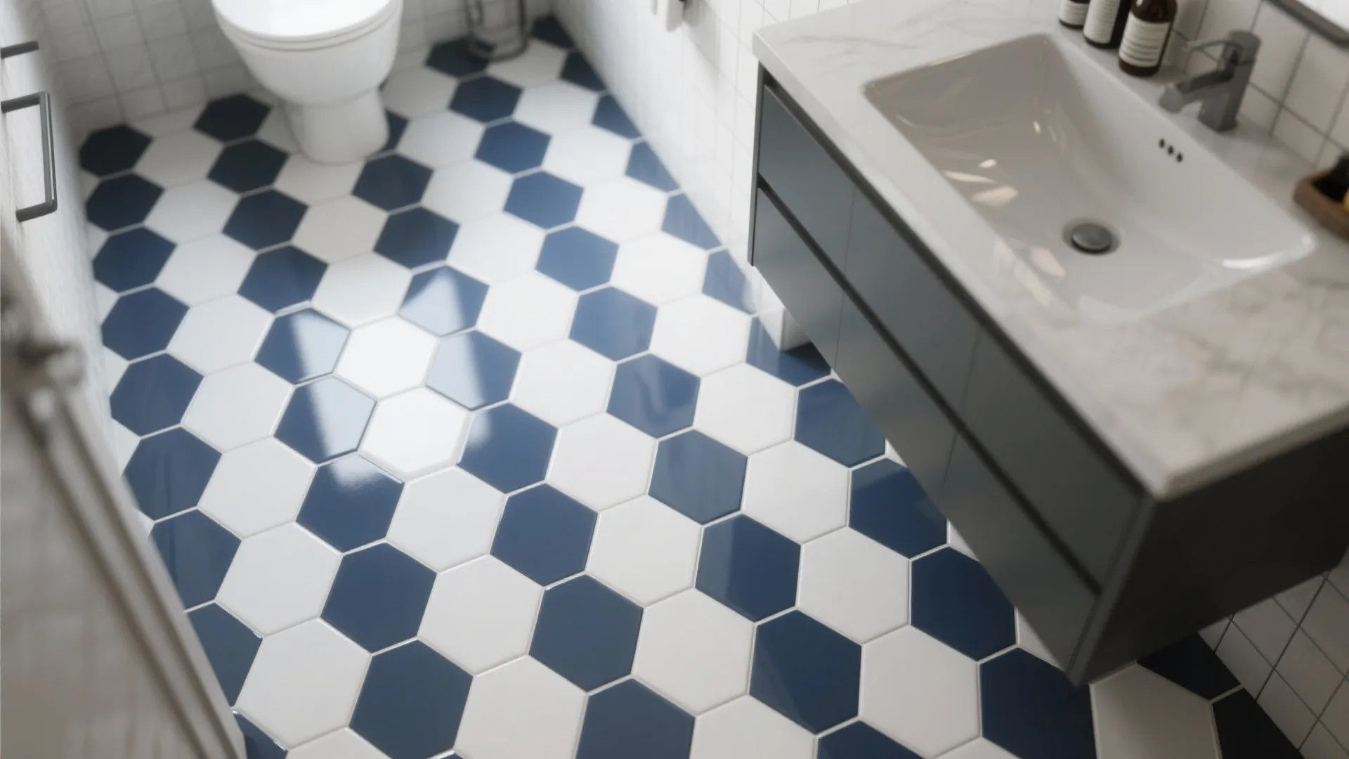 Modern bathroom with blue and white hexagon floor tiles, white toilet, and dark grey cabinet