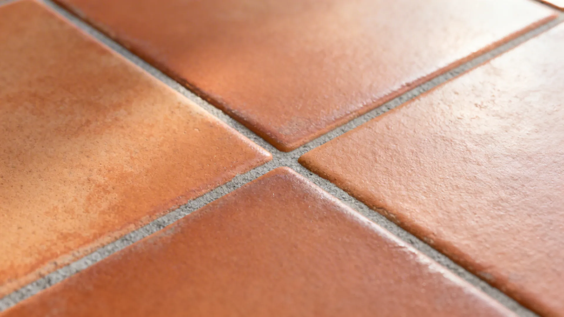 Macro of terracotta-tone porcelain tile with subtle clay-like texture