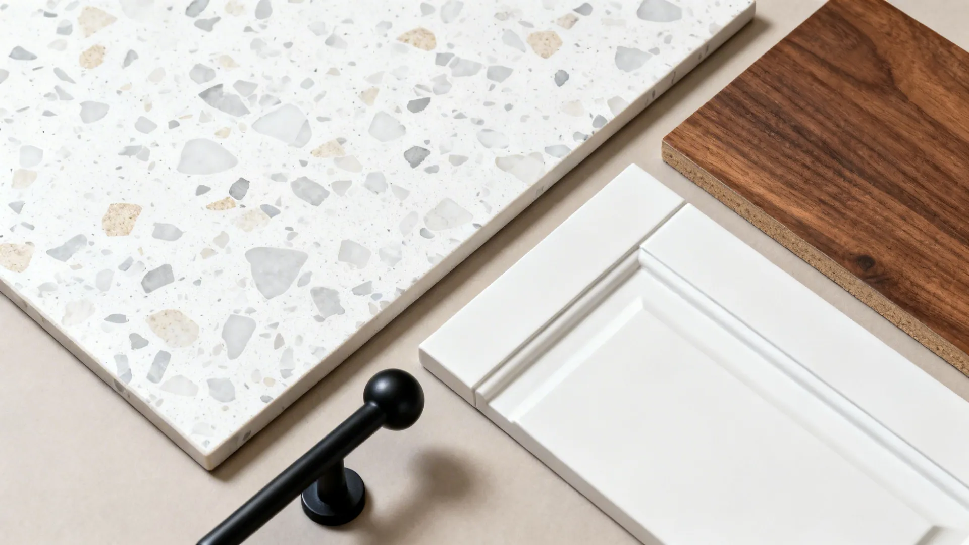 Flat lay with white terrazzo-look tile, wood, white cabinet, and black hardware.