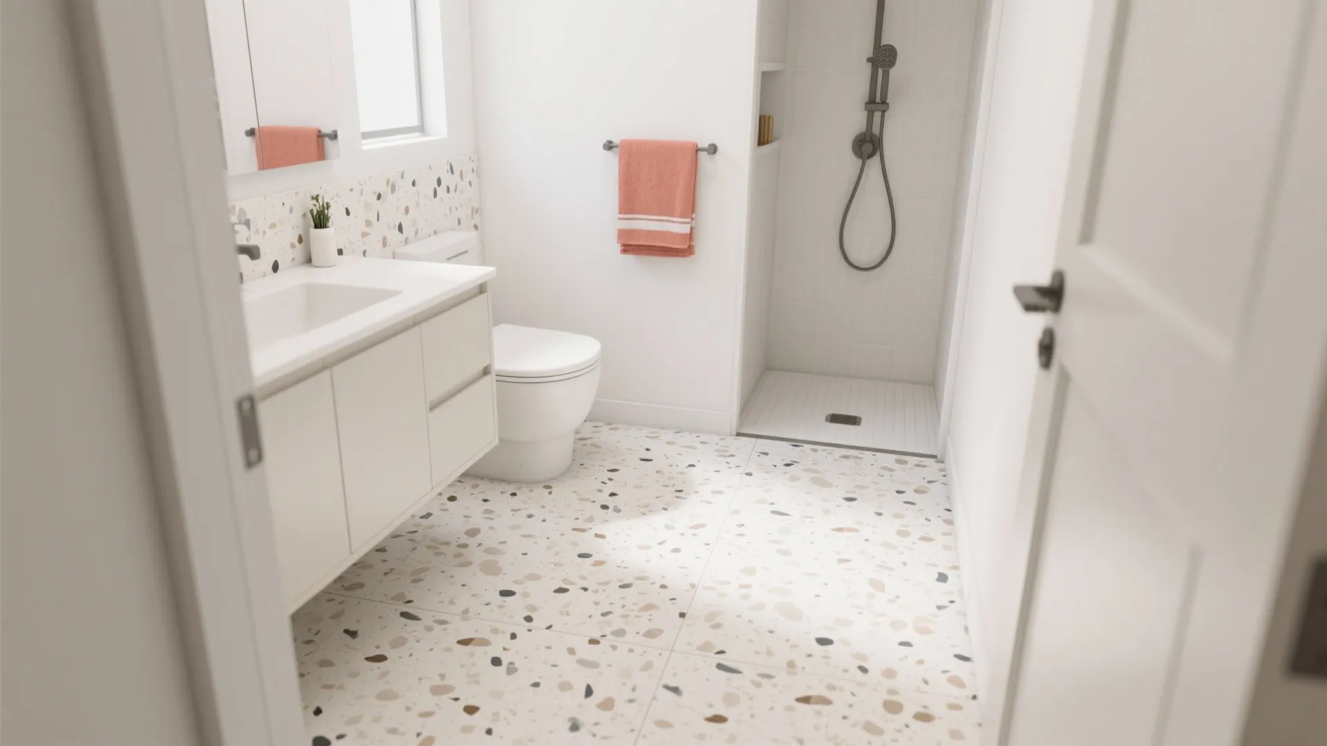 Bright bathroom featuring terrazzo floor tiles white vanity cabinet pink towel and walk in shower