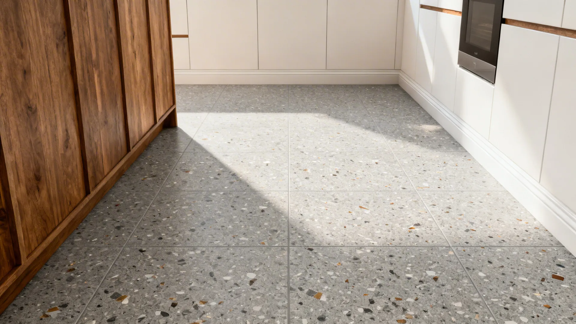 Soft gray terrazzo-look porcelain floor grounding a wood-and-white kitchen.
