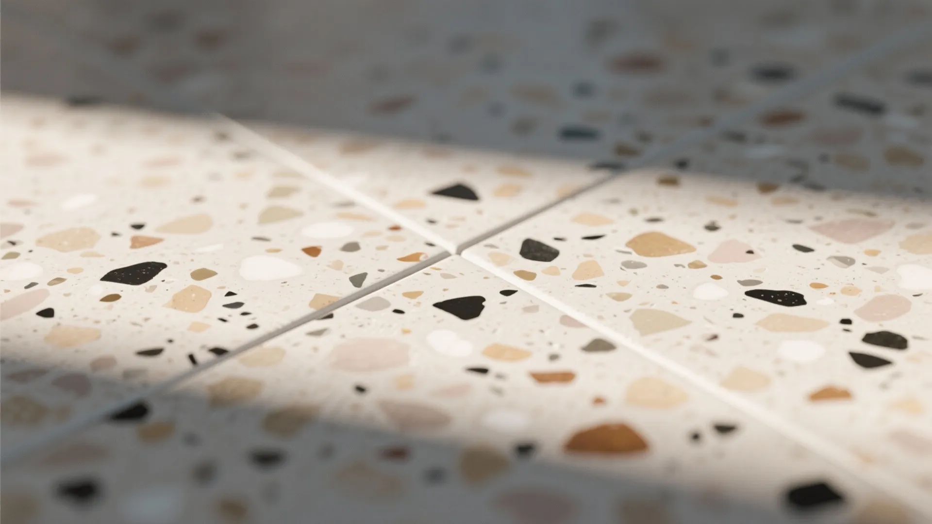 Close up view of floor tiles with colorful stone pieces and natural sunlight across surface