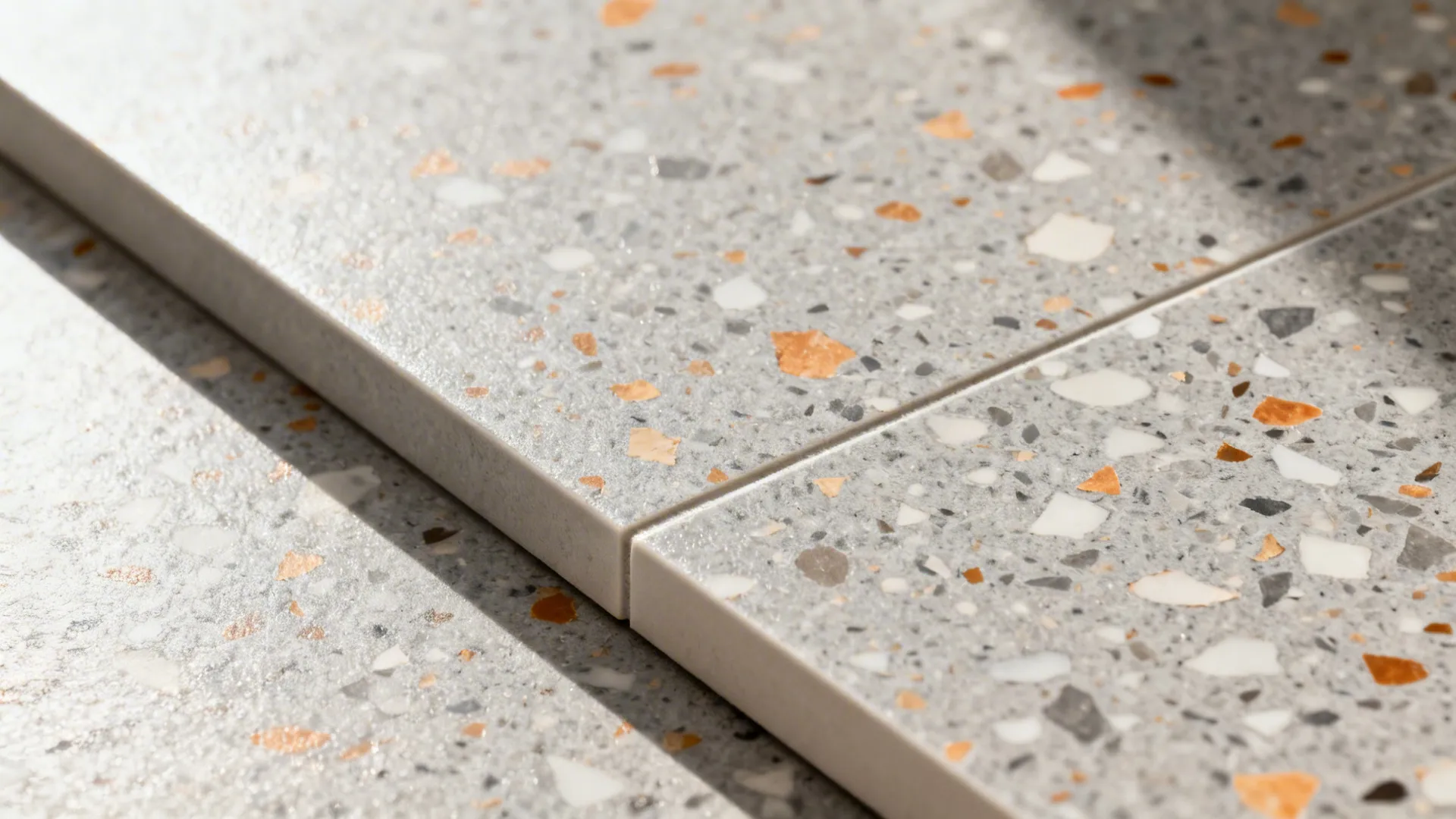 Macro of terrazzo-look decolam backsplash showing detailed chips and clean sealed joint.