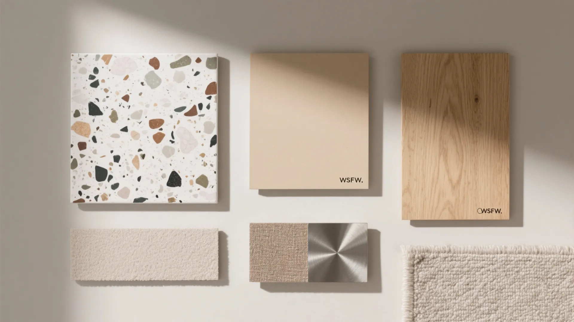 Interior design material board with stone tiles, wood floor samples, beige fabric, and textured carpet