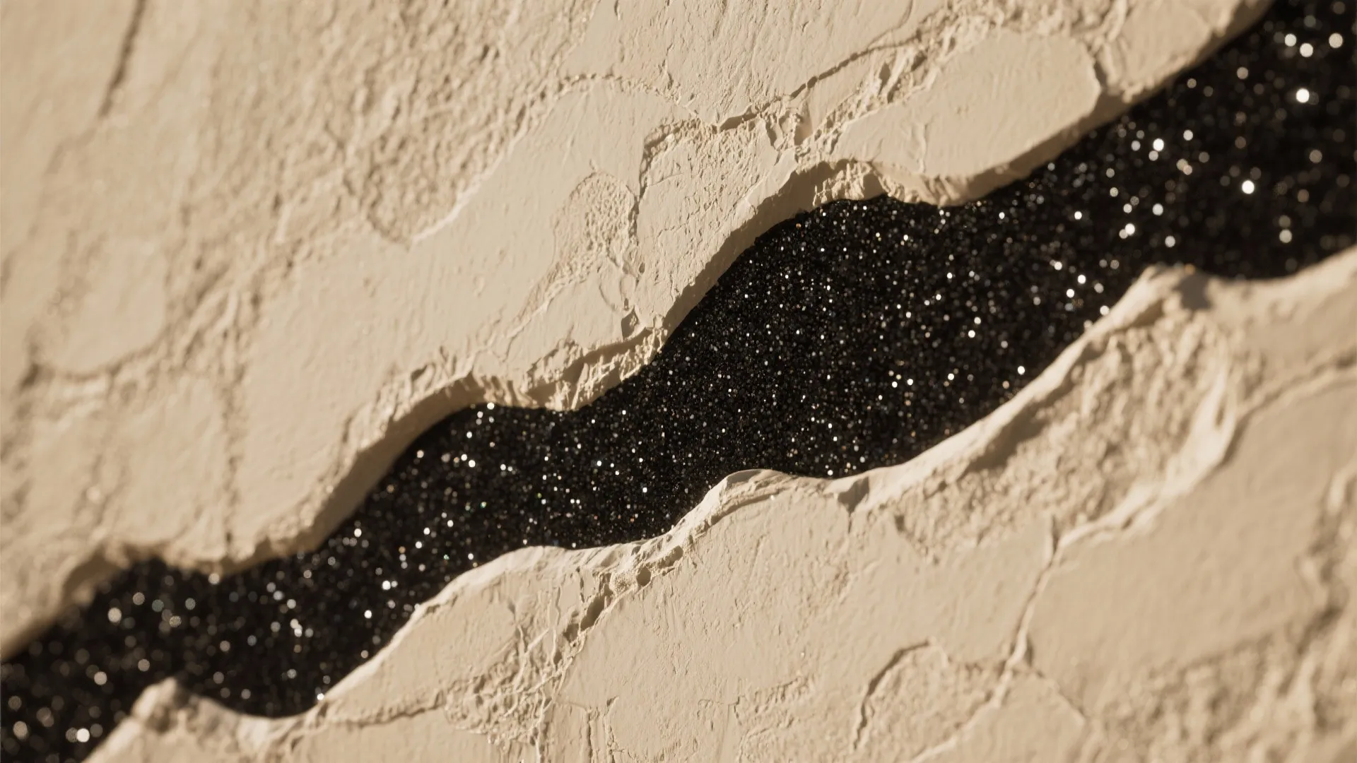 Close up of beige textured wall material with a black glittery stripe in the middle