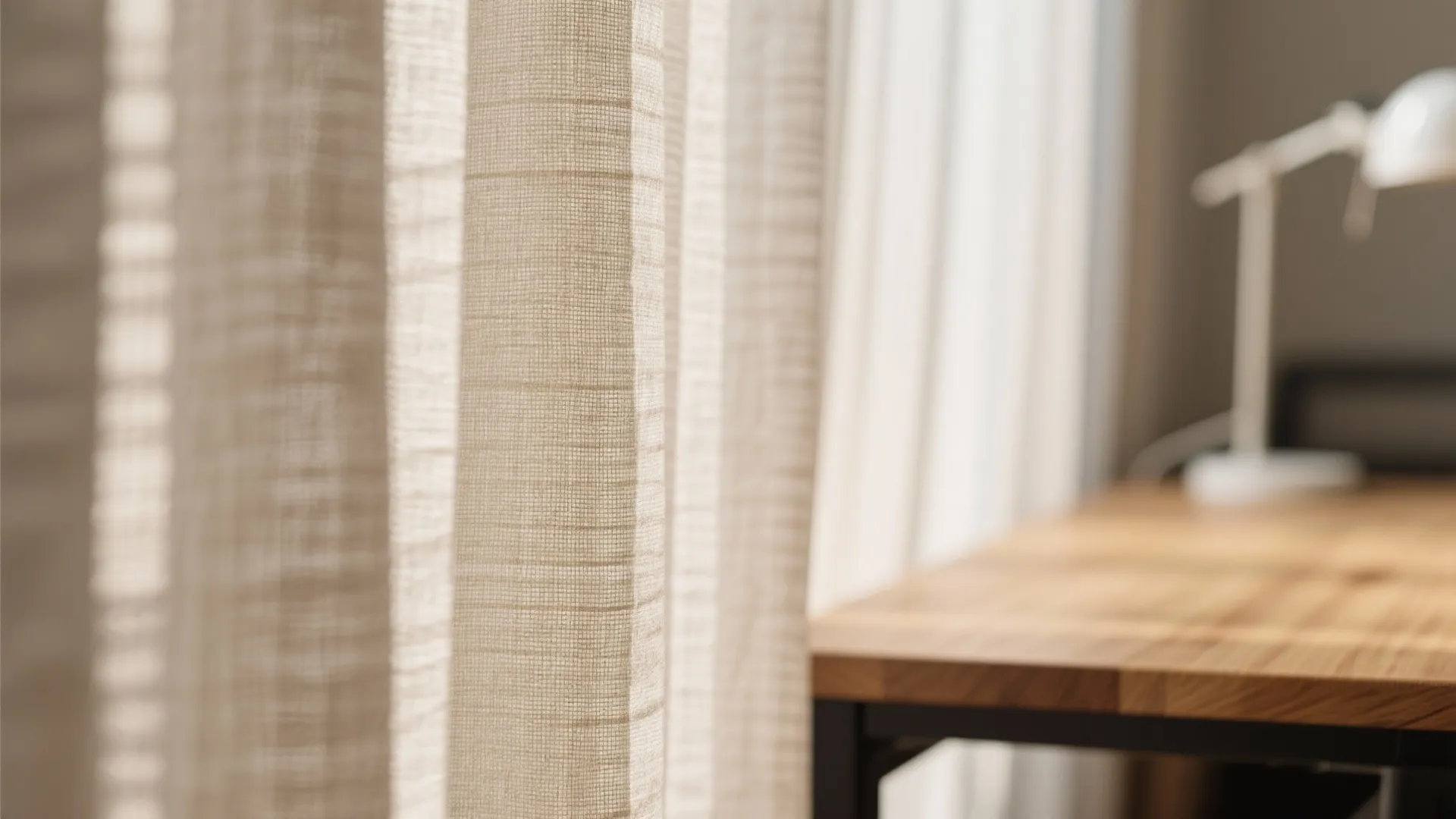 Close-up of natural linen curtains and wood desk texture