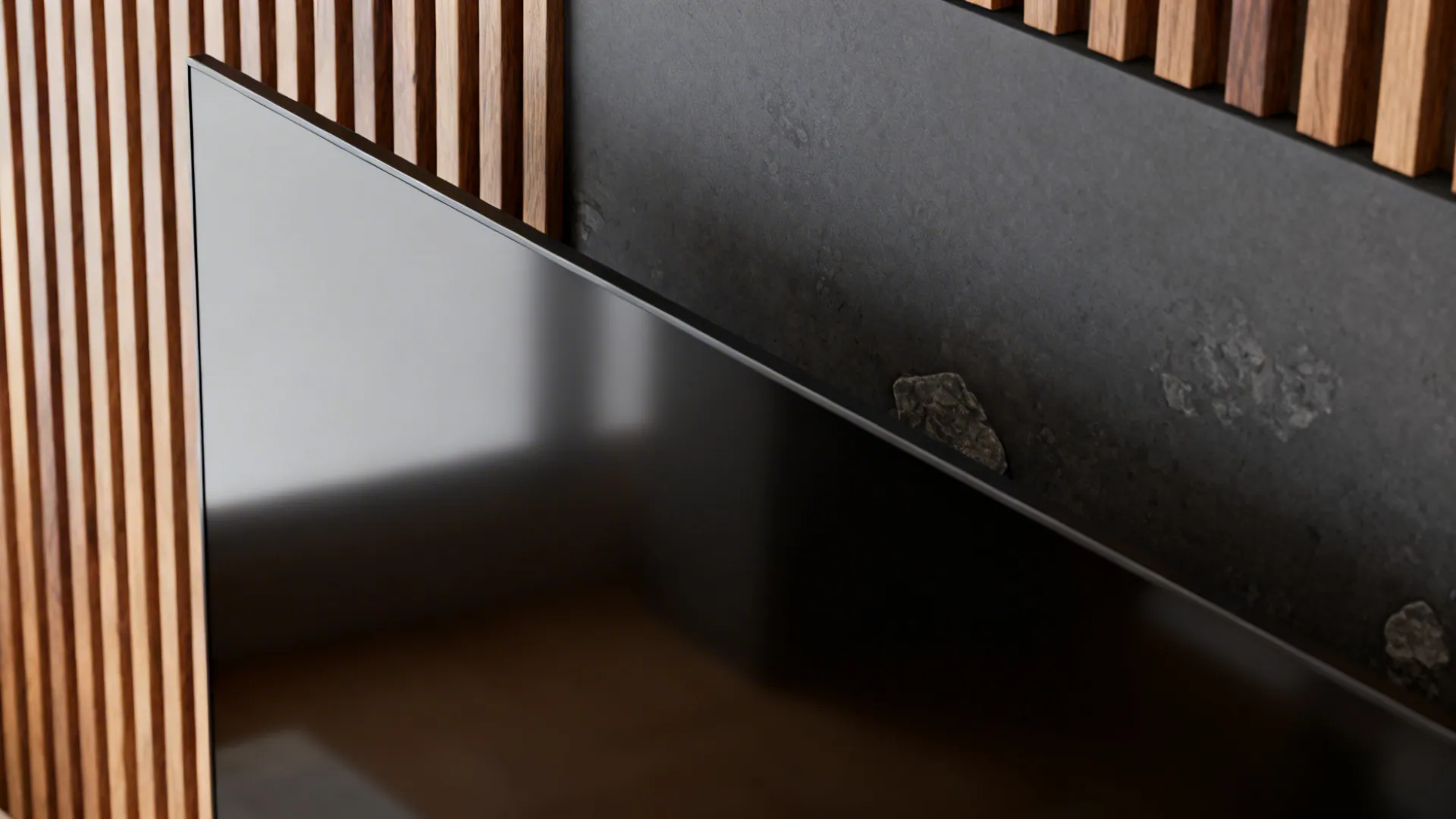 Close up of a black television screen against a wall with wood slats and stone
