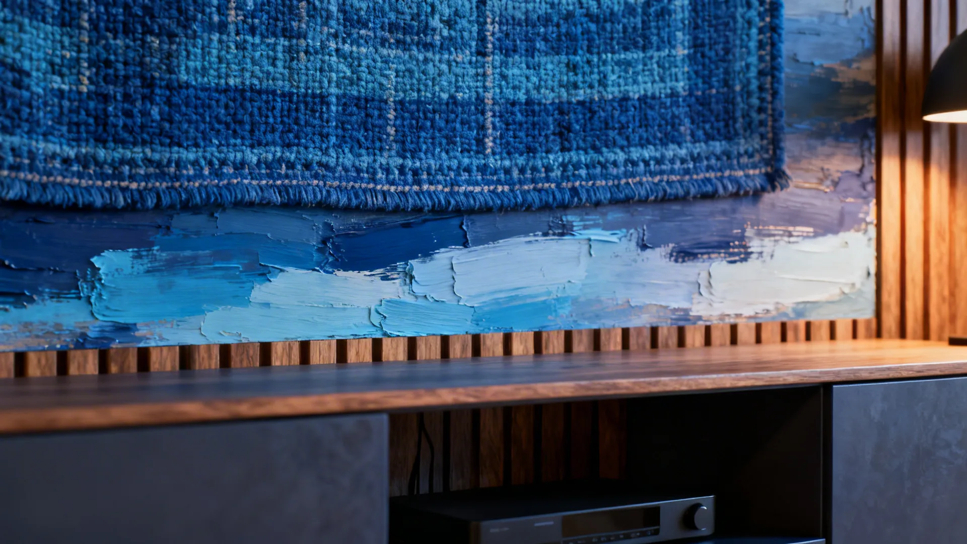 Textured blue tapestry and layered wood panels adding warmth above a media console.