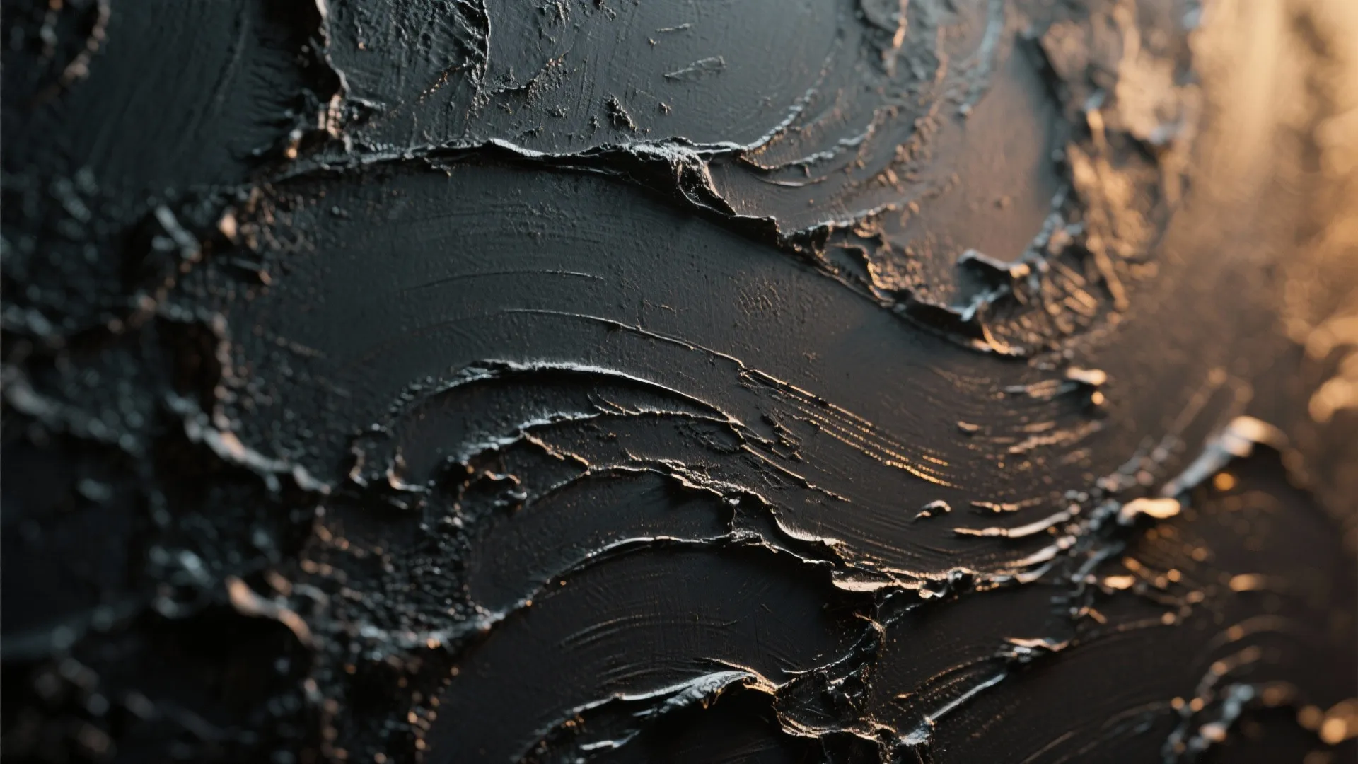 Close up view of black textured wall paint with thick brush strokes and warm lighting
