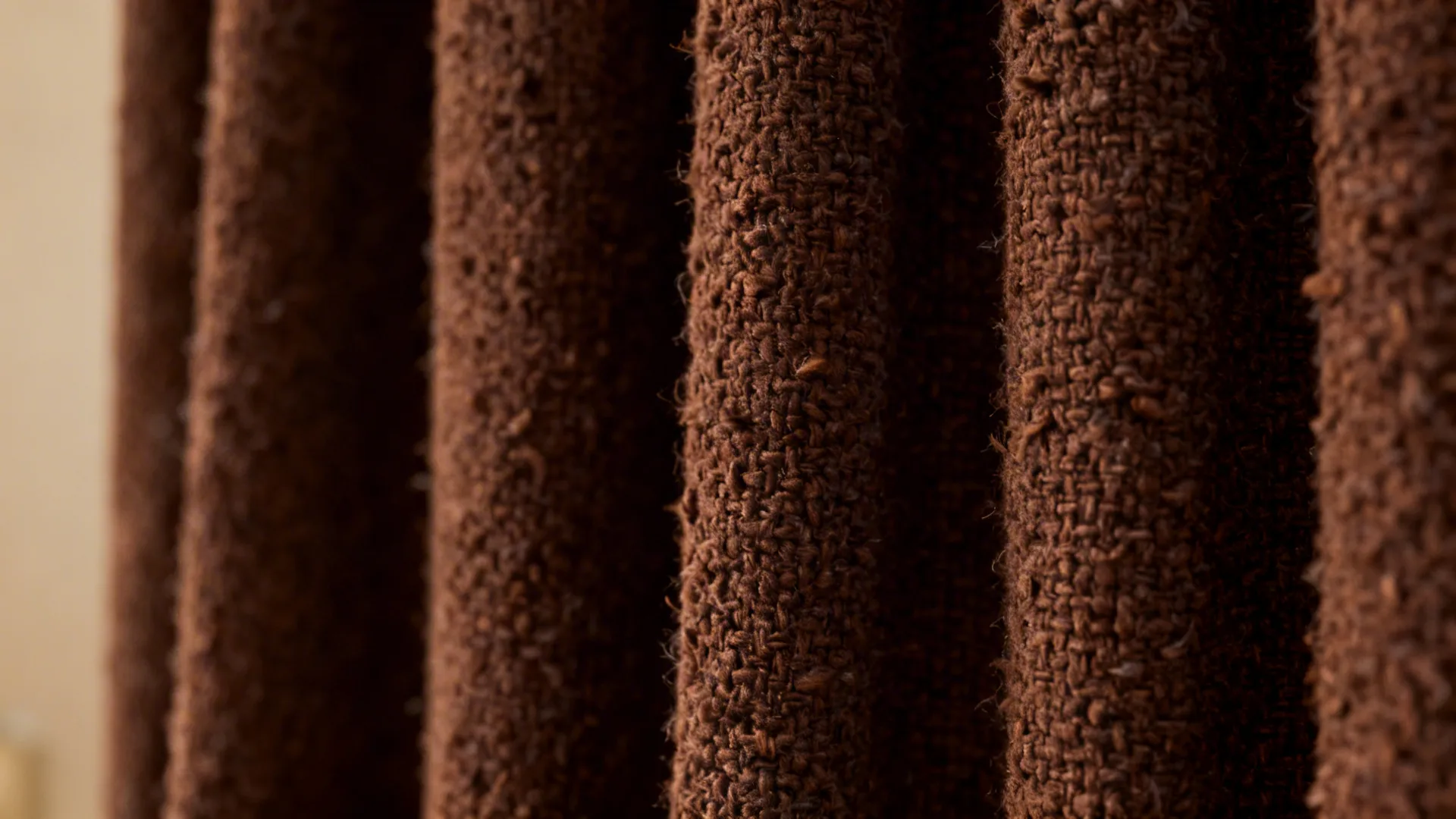 Close up view of thick brown textured fabric with a soft and heavy woven pattern